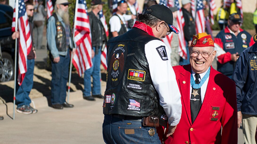 Hershel "Woody" Williams, Marine survivor from the battle of Iwo Jima and the last living Medal of Honor recipient for his actions during the battle, walks past Patriot Guard Riders who lined the walkway from the hotel to the Wellington Center where events were held during the Iwo Jima Battle Survivors and Family Association 70th anniversary reunion at Wichita Falls, Texas, February 14, 2015. Survivors and their families gathered for four days to share remeberances and commeraderie, and to remember and honor the service members who died during the battle and survivors who have died.