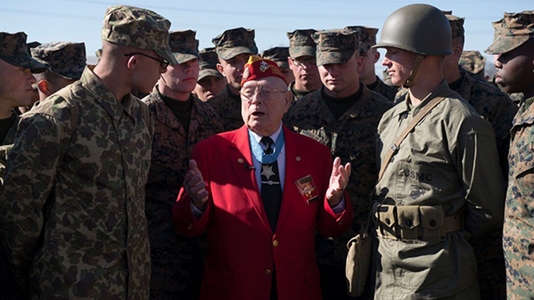 Marines from the Marine Artillery Detachment at Fort Sill, Oklahoma gather around Marine veteran and Medal of Honor recipient Hershel "Woody" Williams after a ceremony held to honor Iwo Jima veterans and their service February 19, 2015. Williams is the last surviving veteran who was awarded the Medal of Honor for his actions during the battle for Iwo Jima.