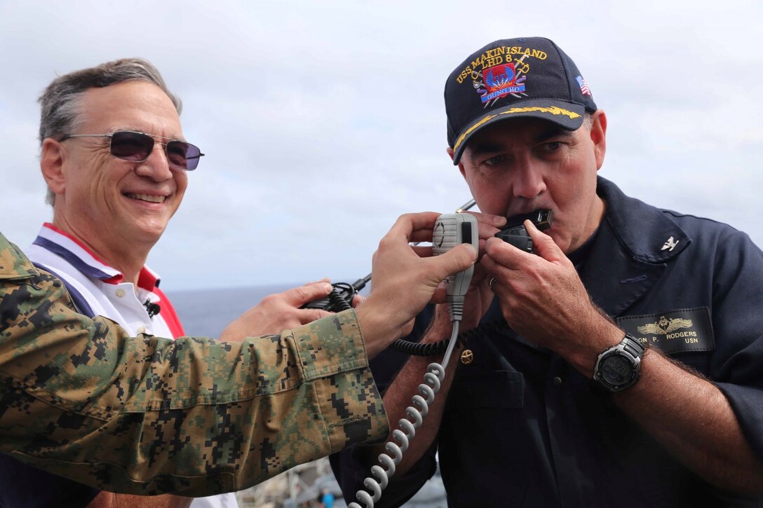 Capt. Jon Rogers, the USS Makin Island commanding officer, plays his harmonica for the captain and crew of the International Space Station during an amateur radio test aboard the amphibious assault ship USS Makin Island, Feb. 19. With the help of Marine radio operators with the 11th Marine Expeditionary Unit, personnel on ship utilized amateur radio equipment to establish direct communication with the International Space Station from the Makin Island. Embarked aboard the three ships of the Makin Island Amphibious Ready Group, the 11th MEU has provided a flexible, sea-based, crisis response force to regional commanders throughout its seven-month Western Pacific deployment. (U.S. Marine Corps photos by Cpl. Demetrius Morgan/Released)     