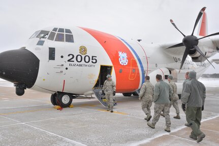 Pararescue Jumpers and Combat Rescue Officers with the 103rd Rescue Squadron of the New York Air National Guard's 106th Rescue Wing at Gabreski Air National Guard Base in Westhampton Beach, N.Y., board a United States Coast Guard HC-130  during a visit of Coast Guardsmen from Air Station Elizabeth City, N.C.,  to discuss possible joint training, compare rescue tactics and showcase squadron equipment and training  Feb. 5, 2015.