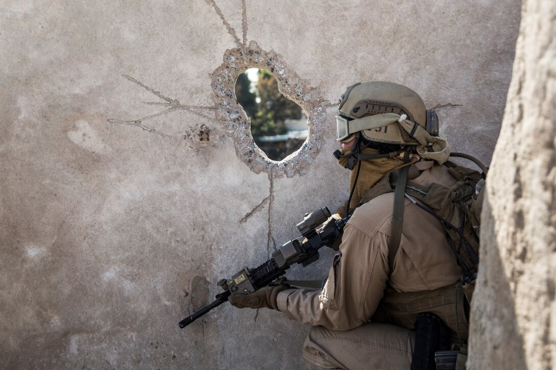A U.S. Marine with the 15th Marine Expeditionary Unit’s Force Reconnaissance Detachment assesses the environment during military operations in urban terrain training aboard Camp Pendleton, Calif., Feb. 19, 2015. These Marines are a part of the MEU’s Maritime Raid Force. The training provides the MEU with the opportunity to train for similar environments in preparation for their upcoming deployment. (U.S. Marine Corps photo by Sgt. Emmanuel Ramos/Released)