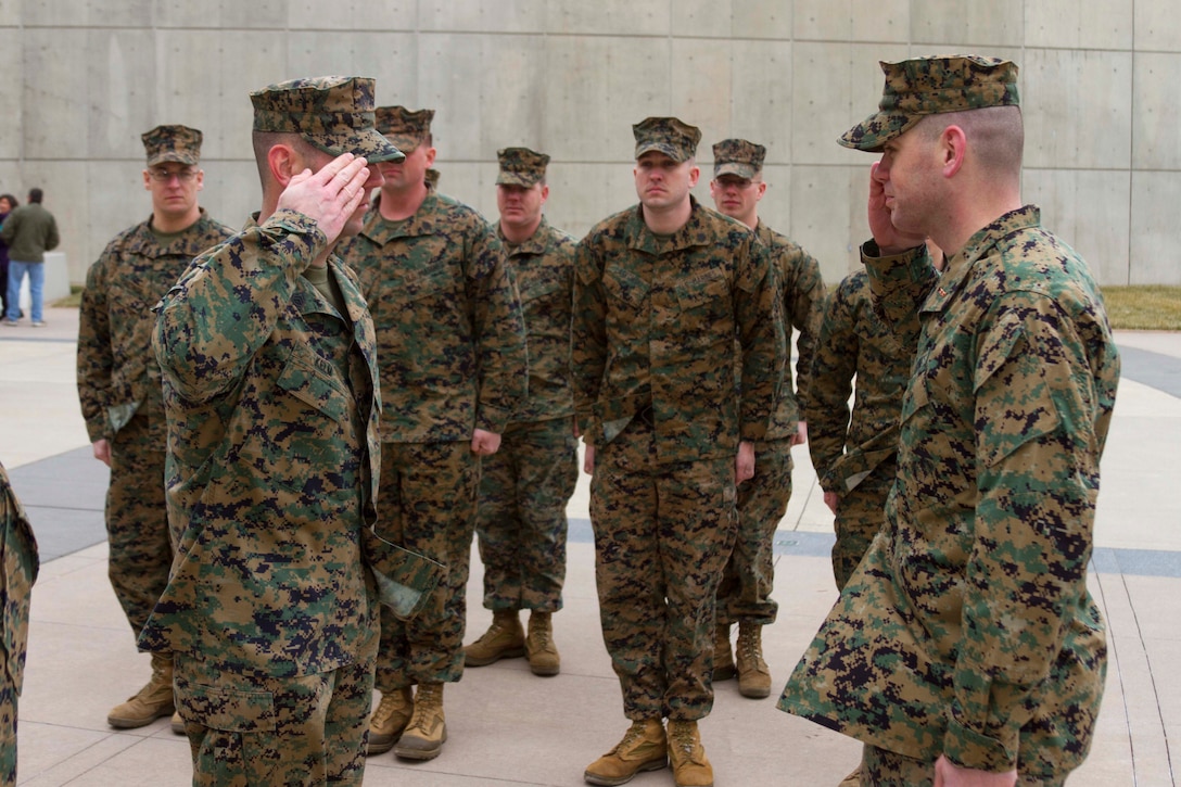 U.S. Marine Corps Chief Warrant Officer 2 Douglas McGlothlin, right, receives his first salute from Gunnery Sgt. Robert Kelm, left, at the National Museum of the Marine Corps, Feb. 5, 2015. McGlothlin, a native of Waldorf, Maryland, enlisted in the Marine Corps 15 years ago and achieved the rank of gunnery sergeant prior to being appointed a chief warrant officer 2. (U.S. Marine Corps photo by Sgt. Bryan Nyggard/RELEASED)