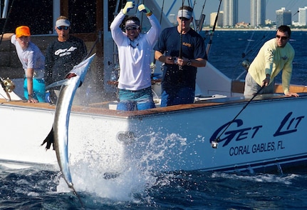 Florida Army National Guard's Maj. Peter Jennison and his son, Morgan, bring in a sailfish off the coast of Miami Beach, Fla., during a taping of the "Bass 2 Billfish" sport fishing show in late January. The Jennisons, along with host, Peter Miller, and the Get Lit Fishing Team, brought in seven sailfish during the saltwater fishing excursion.