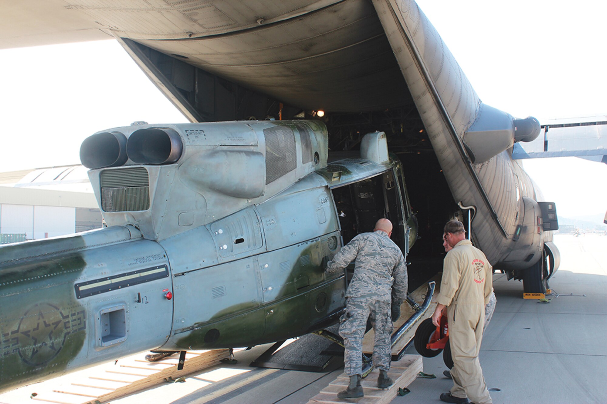 A Huey is loaded into the cargo bay of an MC-130H to be delivered to Kirtland. The Huey will be used for training and is expected to save the military roughly $1 million a year, (Courtesy photo)