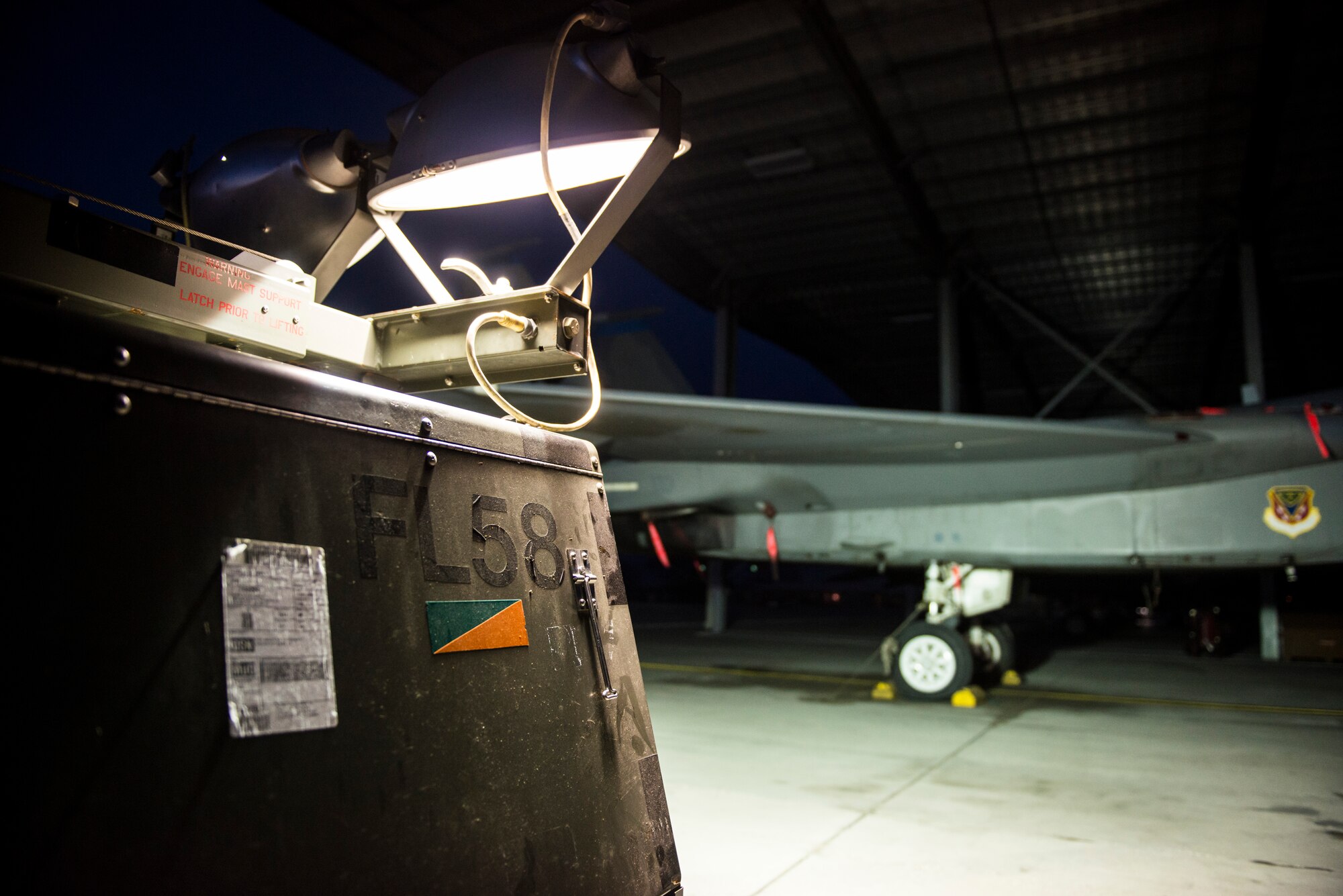 A Light-All lamp cart shines on an F-15E Strike Eagle at Mountain Home Air Force Base, Idaho Feb. 19, 2015. The old light carts have recently been replaced with new overhead lighting on the first four rows of aircraft shelters. "We hope to have the rest of the shelters [lights] to be turned on within the next few months," said Senior Airman Hunter Reynolds, 391st Bold Tigers crew chief. (U.S. Air Force photo by Airman Connor J. Marth/RELEASED)