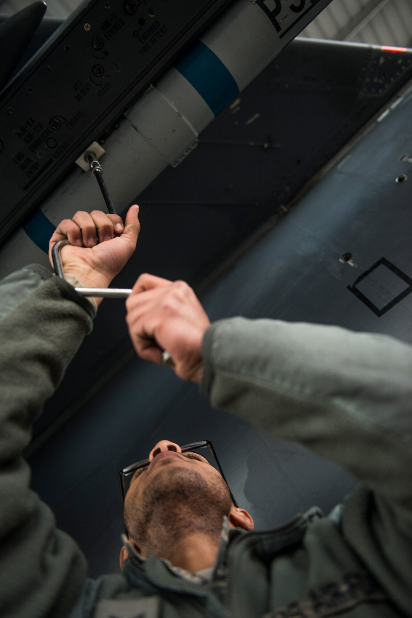 Senior Airman Darrius Cole, 391st Bold Tigers weapons loadcrew member, sets an Airborne Instrument System Pod on an F-15E Strike Eagle Feb. 19, 2015 at Mountain Home Air Force Base, Idaho. Recently updated lighting has helped to improve the working conditions of maintainers and flightline Airmen during hours of darkness. "It's almost like there's still daylight outside," said Jeffrey Thompson, 391st Bold Tigers crew chief.  (U.S. Air Force photo by Airman Connor J. Marth/RELEASED)