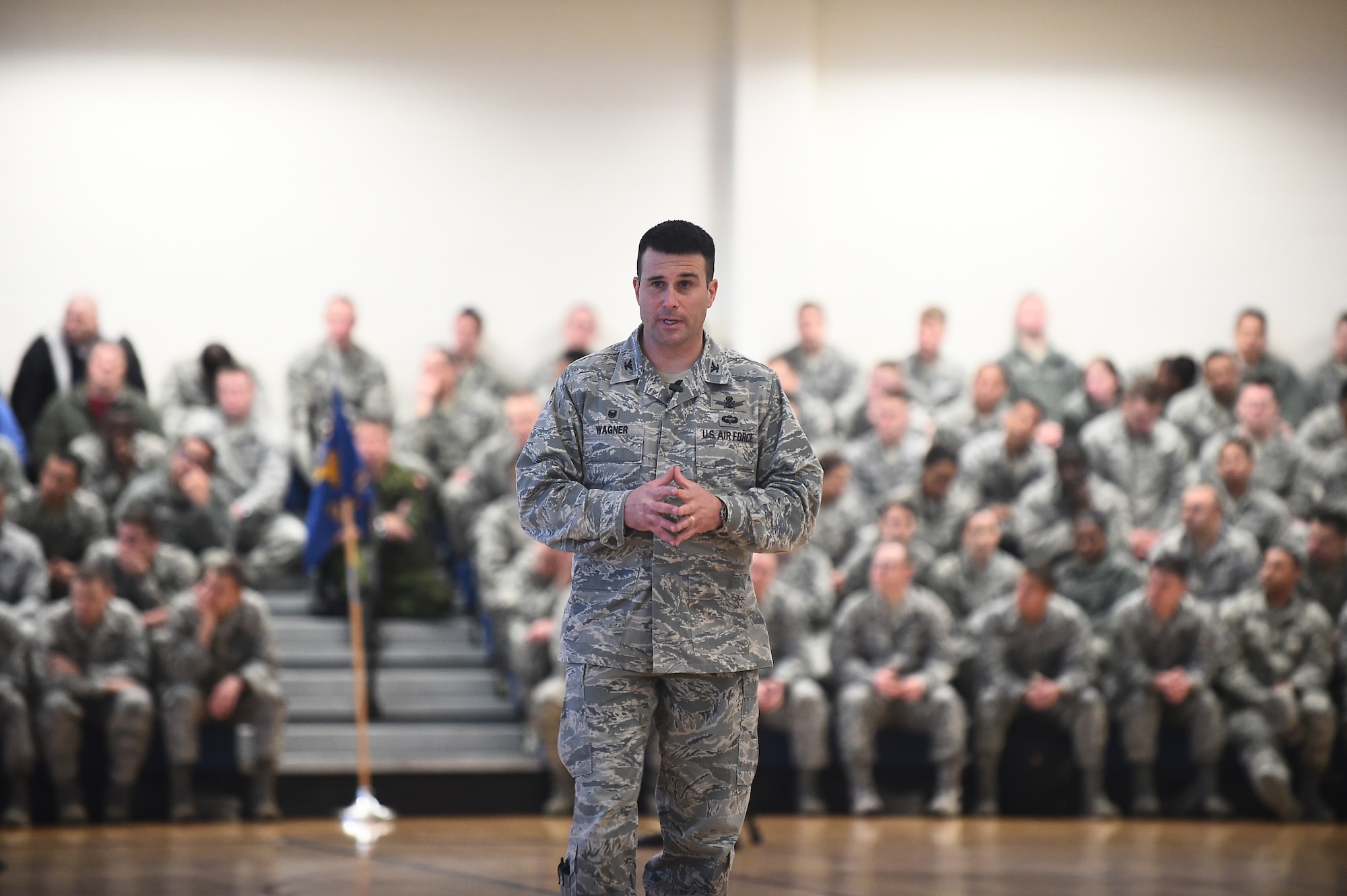 Col. John Wagner, 460th Space Wing commander, addresses Team Buckley members at the first commander’s call of the year Feb. 19, 2015, at Buckley Air Force Base, Colo. The commander’s call outlined the challenges facing the Air Force today and what needs to be done to improve upon current operating procedures. (U.S. Air Force photo by Airman 1st Class Luke W. Nowakowski/Released)