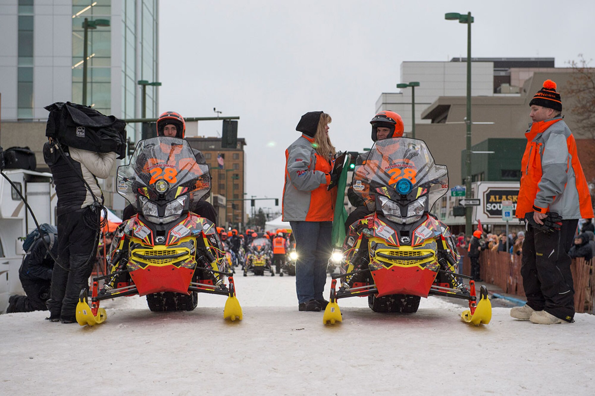 Iron Dog racers, Jason Gunderson, left, and Josh Norum prepare to start the 2,000 mile-long course in Anchorage, Alaska, Feb. 21, 2015. For the first time, this year's race course passed through Joint Base Elmendorf-Richardson. (U.S. Air Force photo/Alejandro Pena)