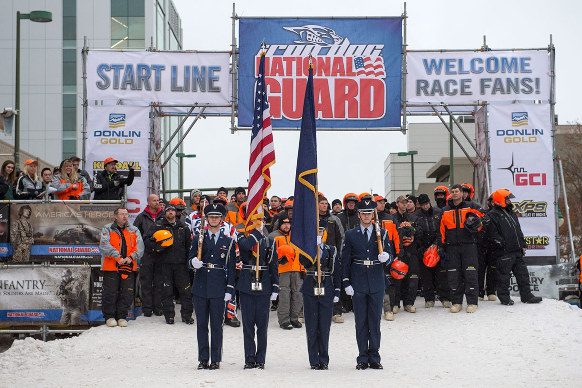 The Joint Base Elmendorf-Richardson Air Force Honor Guard participates in the opening ceremony for the 2015 Iron Dog race in Anchorage, Alaska, Feb. 21. This year's Iron Dog was sponsored by several organizations, including the Alaska National Guard. (U.S. Air Force photo/Alejandro Pena)