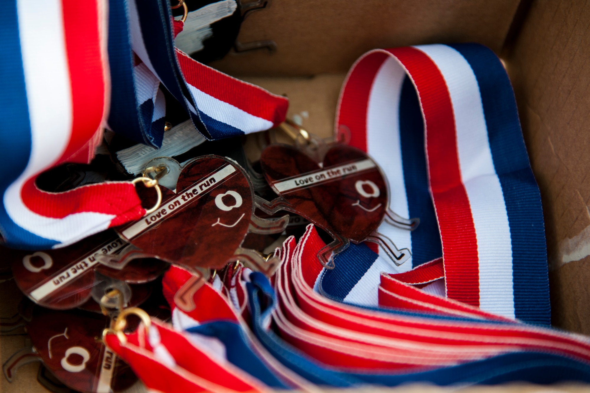 GOODFELLOW AIR FORCE BASE, Texas -- Medals for the Heart Healthy 5k sit in a box, on Kiowa Trail Feb. 21. The president and congress established Heart Healthy Month in 1963. (U.S. Air Force photo/Senior Airman Michael Smith)		