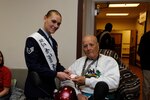 Air Force Staff Sgt. Stephanie Hall, 2015 Joint Base San Antonio military ambassador, hands a valentine to Alfredo Espinosa during the 2015 National Salute to Veteran Patients program Feb. 13 at the Audie L. Murphy Memorial Veterans Hospital. (U.S. Air Force photo by Harold China)