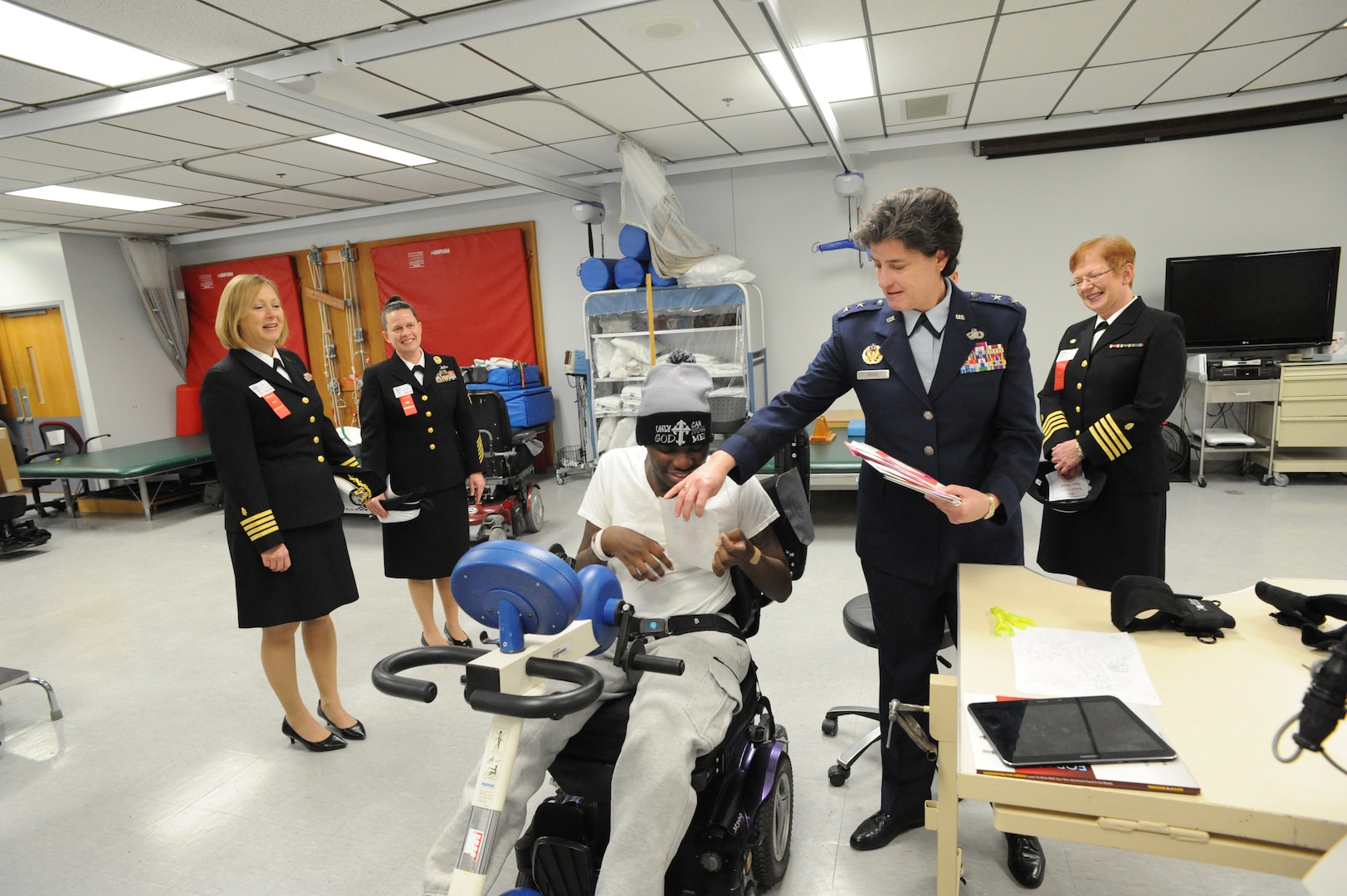 Maj. Gen. Peggy Poore (right), Air Force Personnel Center commander, hands a valentine to Thomas Taylor (center), Army National Guard, during the 2015 National Salute to Veteran Patients program Feb. 13 at Audie L. Murphy Memorial Veterans Hospital. The military ambassadors and Joint Base San Antonio military leaders distributed valentines and visited with veteran patients. Veterans’ Administration facilities across the United States pay tribute to veteran patients annually during the week-long salute. (U.S. Air Force photo by Melissa Peterson)