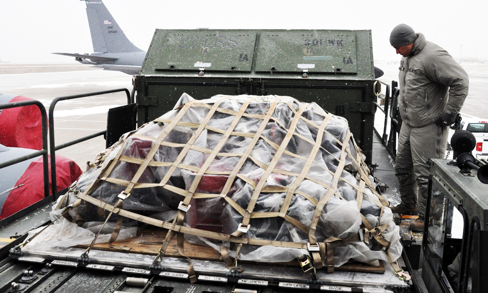 Staff Sgt. Ronald West, 22nd Air Refueling Wing, prepares to move a pallet of cargo from a K-loader to a KC-135 Stratotanker at McConnell Air Force Base, Kan., Feb. 23, 2015. A total force team of logistics personnel and air refueling boom operators from the active duty 22 ARW and Air Force Reserve 931st Air Refueling Group braved sub-freezing temperatures to load approximately 18,000 pounds of cargo onto the aircraft in preparation for Red Flag. Red Flag is a large-scale military training exercise conducted at Nellis Air Force Base, Nev. (U.S. Air Force photo by Capt. Zach Anderson)
