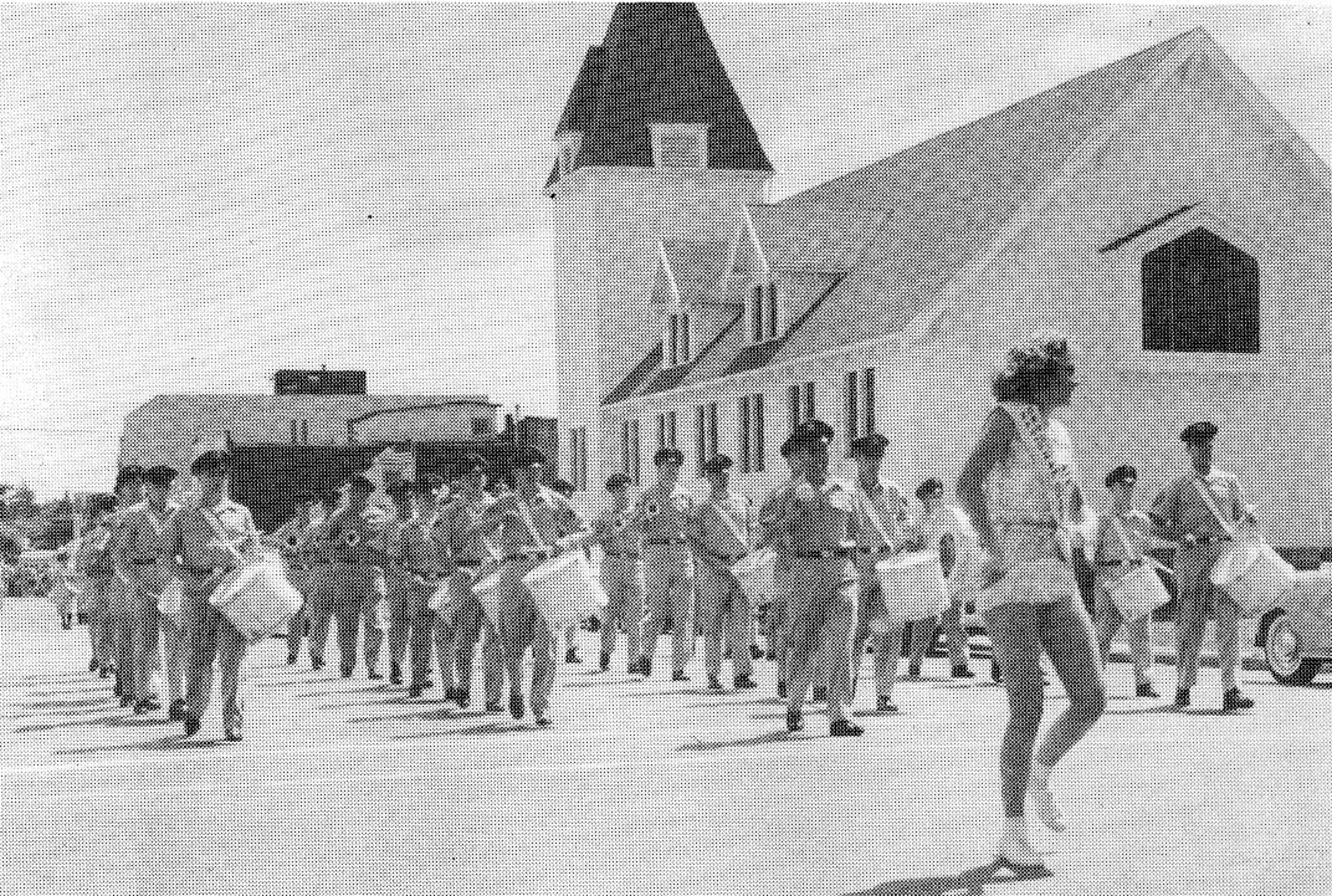 The Twirler leads the OreANG Drum & Bugle Corps through Astoria, Oregon during the Astoria Regatta Parade of Aug. 26, 1961. The corps won Best Performing Drum & Bugle Corps.