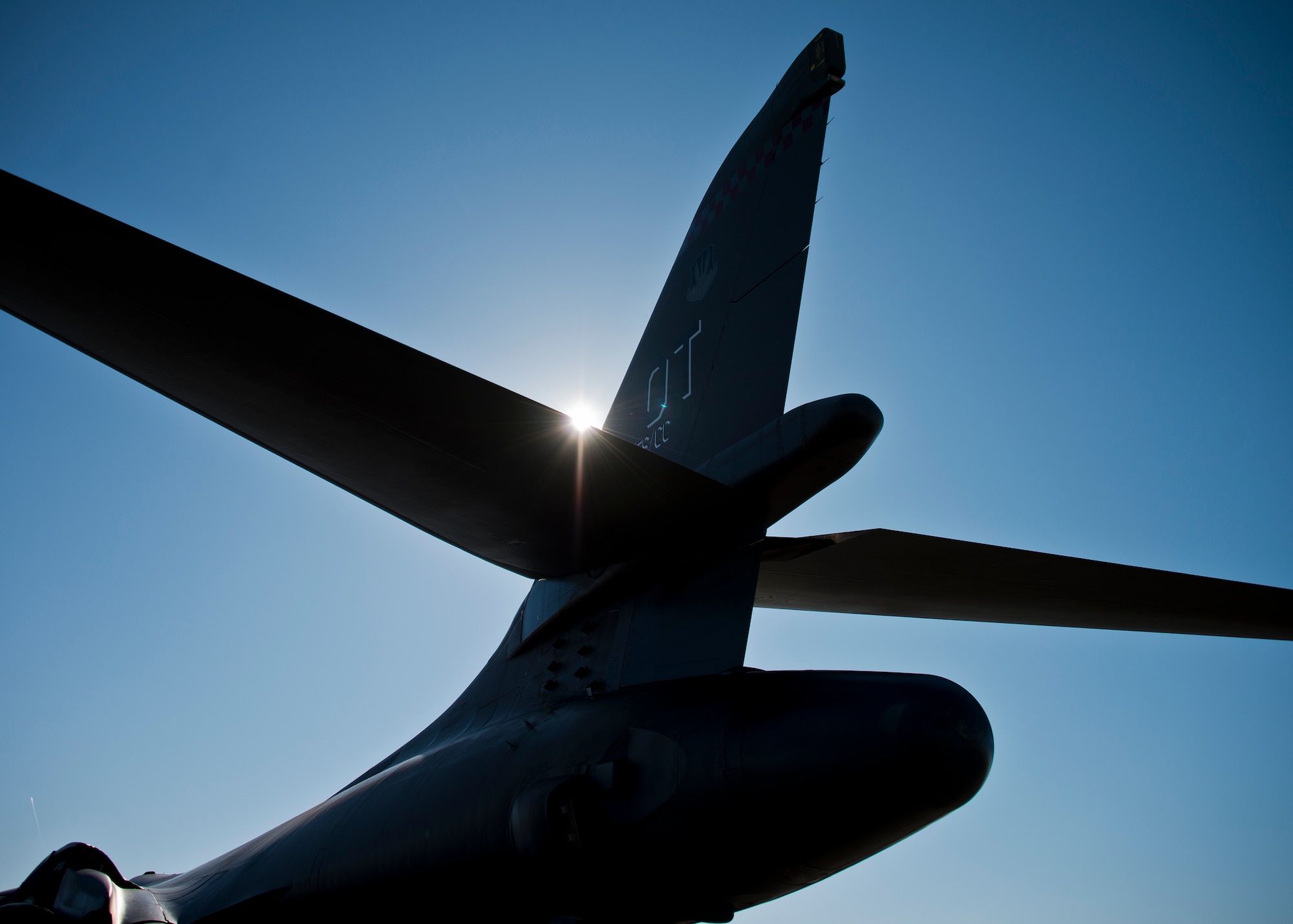 The sun breaks off the tail section of the 53rd Wing’s B-1B Lancer as it sits on the Eglin Air Force Base flightline Feb. 19. The 337th Test and Evaluation Squadron bomber from Dyess AFB, Texas was here for a few missions and to allow wing personnel an opportunity to see one of their geographically separated aircraft up close.  (U.S. Air Force photo/Samuel King Jr.)