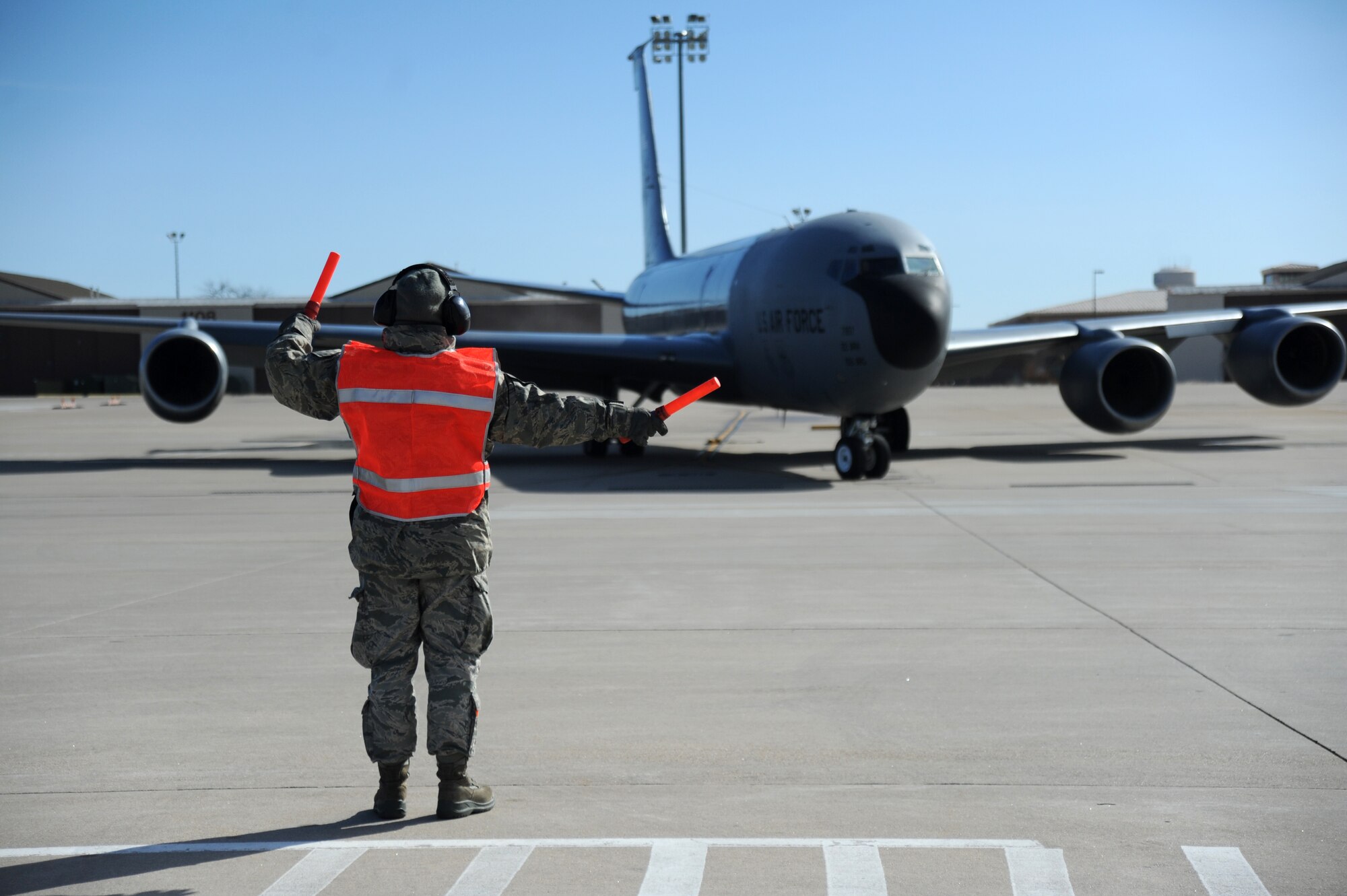 Airman 1st Class Demetria Garcia, 22nd Aircraft Maintenance Squadron crew chief, marshals a KC-135R Stratotanker, Feb. 18, at McConnell Air Force Base, Kan. Crew chiefs finish the flight control check by signaling the pilots the direction and when to head to the runway for takeoff . (U.S. Air Force photo by Airman 1st Class Christopher Thornbury)