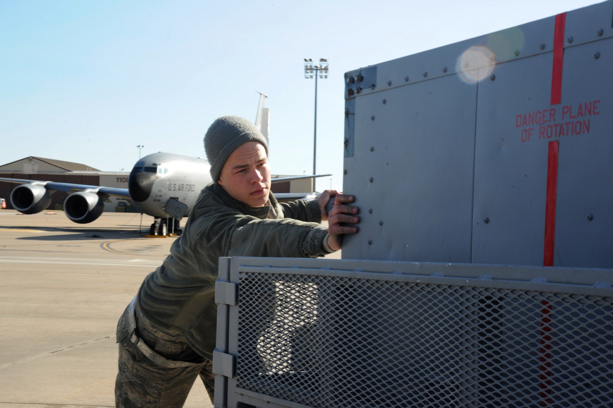 Airman 1st Class Caleb May, 22nd Aircraft Maintenance Squadron crew chief, pushes an air compressor cart into position during a flight control check, Feb. 18, at McConnell Air Force Base, Kan. The air compressor powers the jets to ensure they operate properly before McConnell’s aircraft are flight ready and utilized for the mission of refueling around the globe. (U.S. Air Force photo by Airman 1st Class Christopher Thornbury)