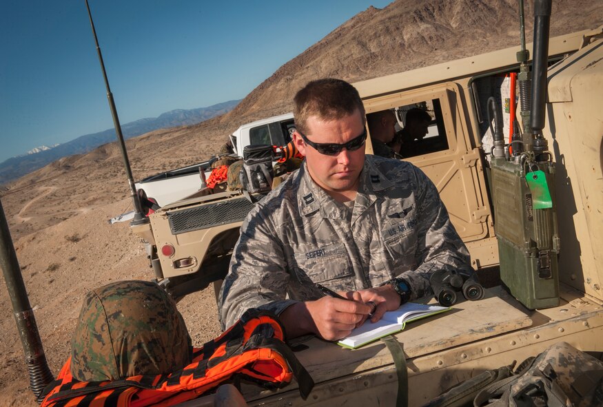 Capt. Bradley Siefert, 69th Bomb Squadron pilot, takes notes during Integrated Training Exercise 2-15 on Marine Corps Air Ground Combat Center Twentynine Palms, Calif., Feb. 12, 2015. Aircrews from the 69th BS provided close-air support to Marine ground units during the exercise. (U.S. Air Force photo/Airman 1st Class Apryl Hall)
