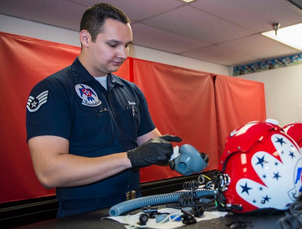 Staff Sgt. Jose Ibarra, U.S. Air Force Air Demonstration Squadron flight equipment specialist, conducts a 30-day breakdown inspection of helmets and oxygen masks at the Thunderbirds Hangar on Nellis Air Force Base, Nev., Feb. 9, 2015. The Thunderbirds squadron is an Air Combat Command unit composed of eight pilots, including six demonstration pilots, four support officers, three civilians and more than 130 enlisted personnel performing in 25 career fields. (U.S. Air Force photo by Staff Sgt. Kristina Overton) 