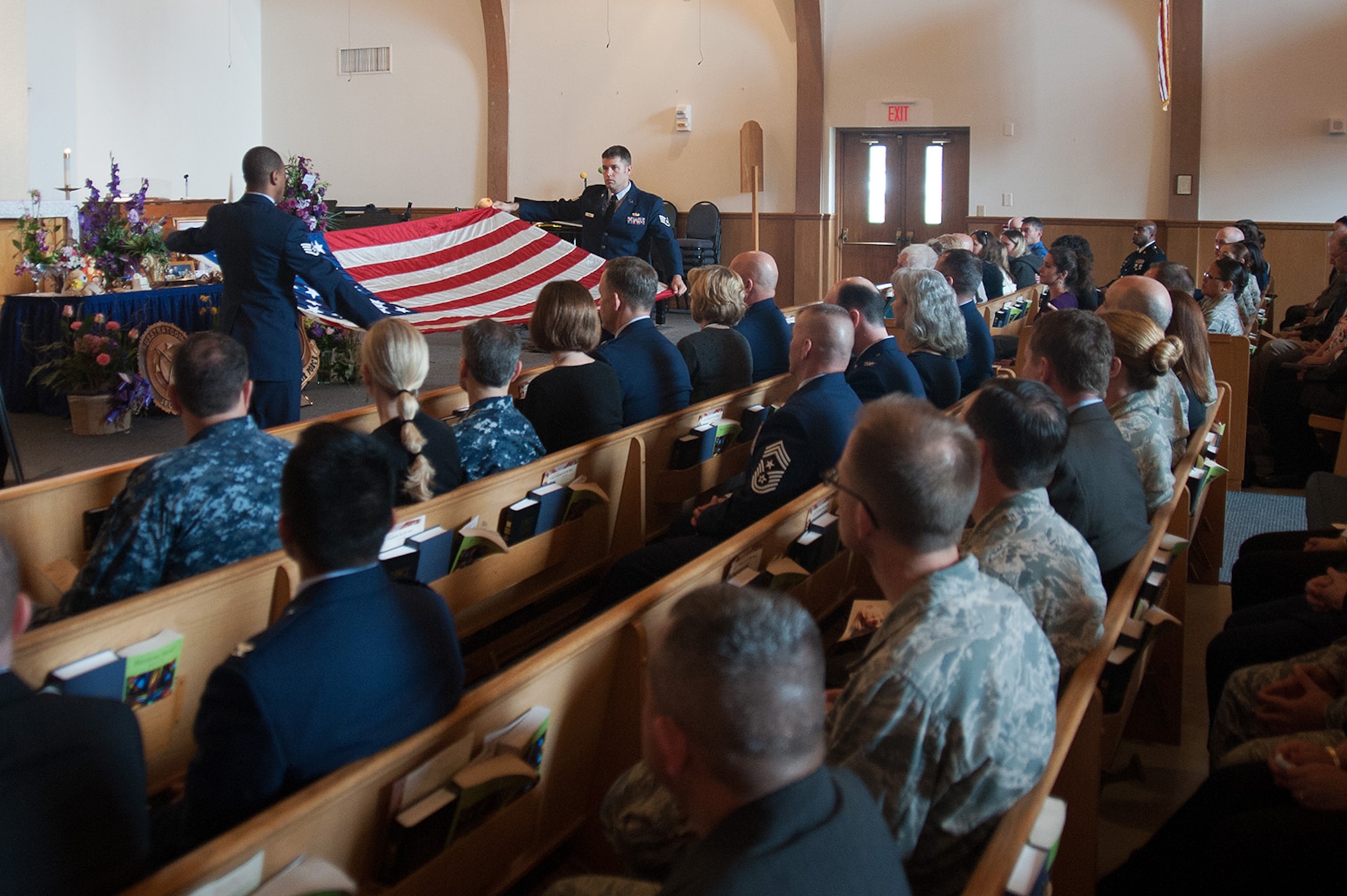 Members of 14th Air Force perform a flag-folding ceremony during a memorial service for Tammy Martin, 14th Air Force Commander’s Secretary, at the base chapel, Feb. 19, 2015.  A 40-year civil servant, “Ms. Tammy,” as she was known, passed away Feb. 12, 2015 following a sudden illness. More than 200 friends, family members and members of her extended Air Force family were on hand to celebrate her life.  (U.S. Air Force photo by Michael Peterson/Released)