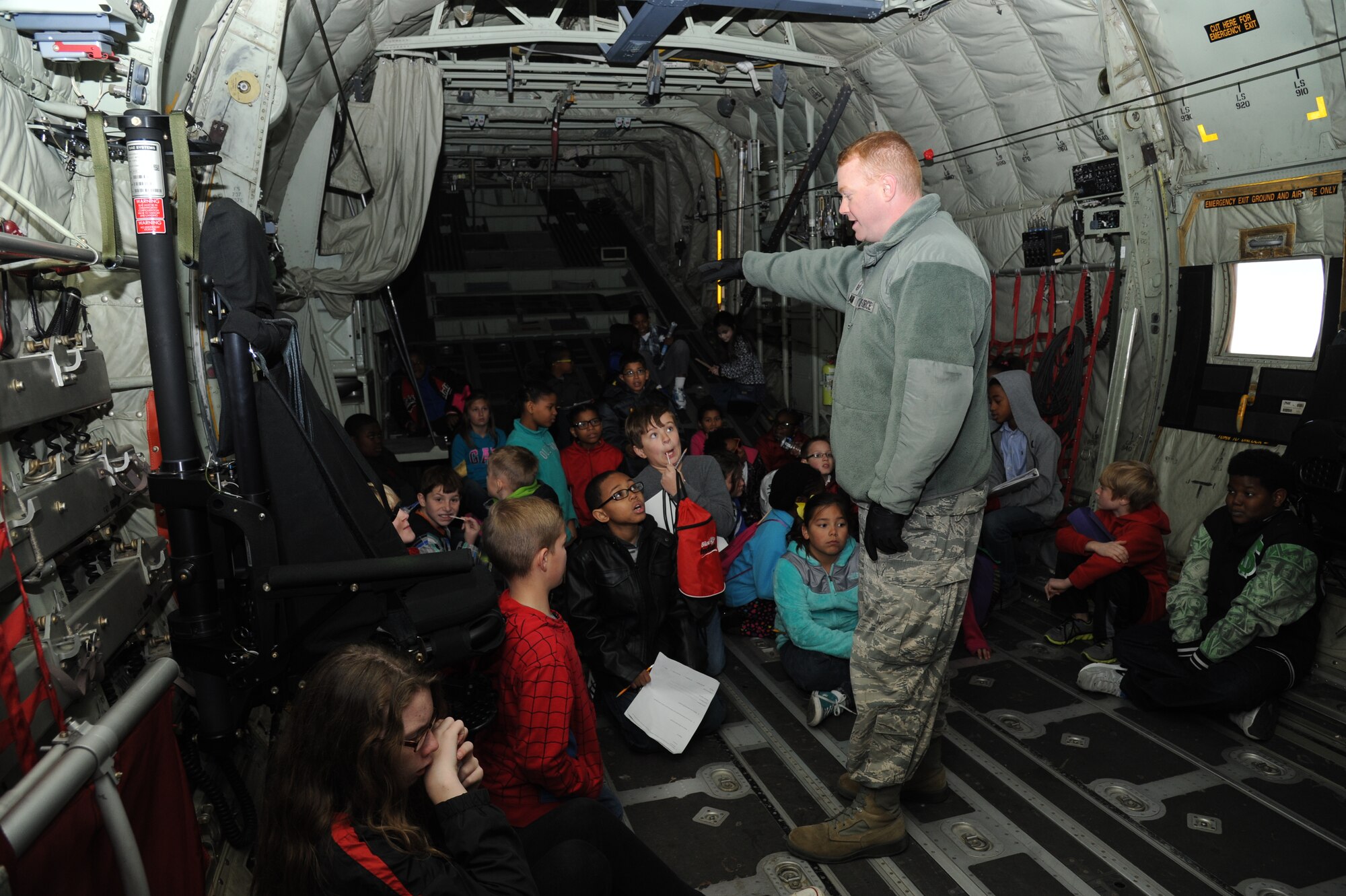 Master Sgt. Brian Lamar, 403rd Wing public affairs specialist, provides a tour of a C-130J Super Hercules to school-aged children during Biloxi Career Exploration Day Feb. 19, 2015, outside the weather complex, Keesler Air Force Base, Miss.  The children also toured the 334th Training Squadron, the 335th TRS, the 81st Security Forces Squadron canine facility and the Keesler Fire Department.  (U.S. Air Force photo by Kemberly Groue)