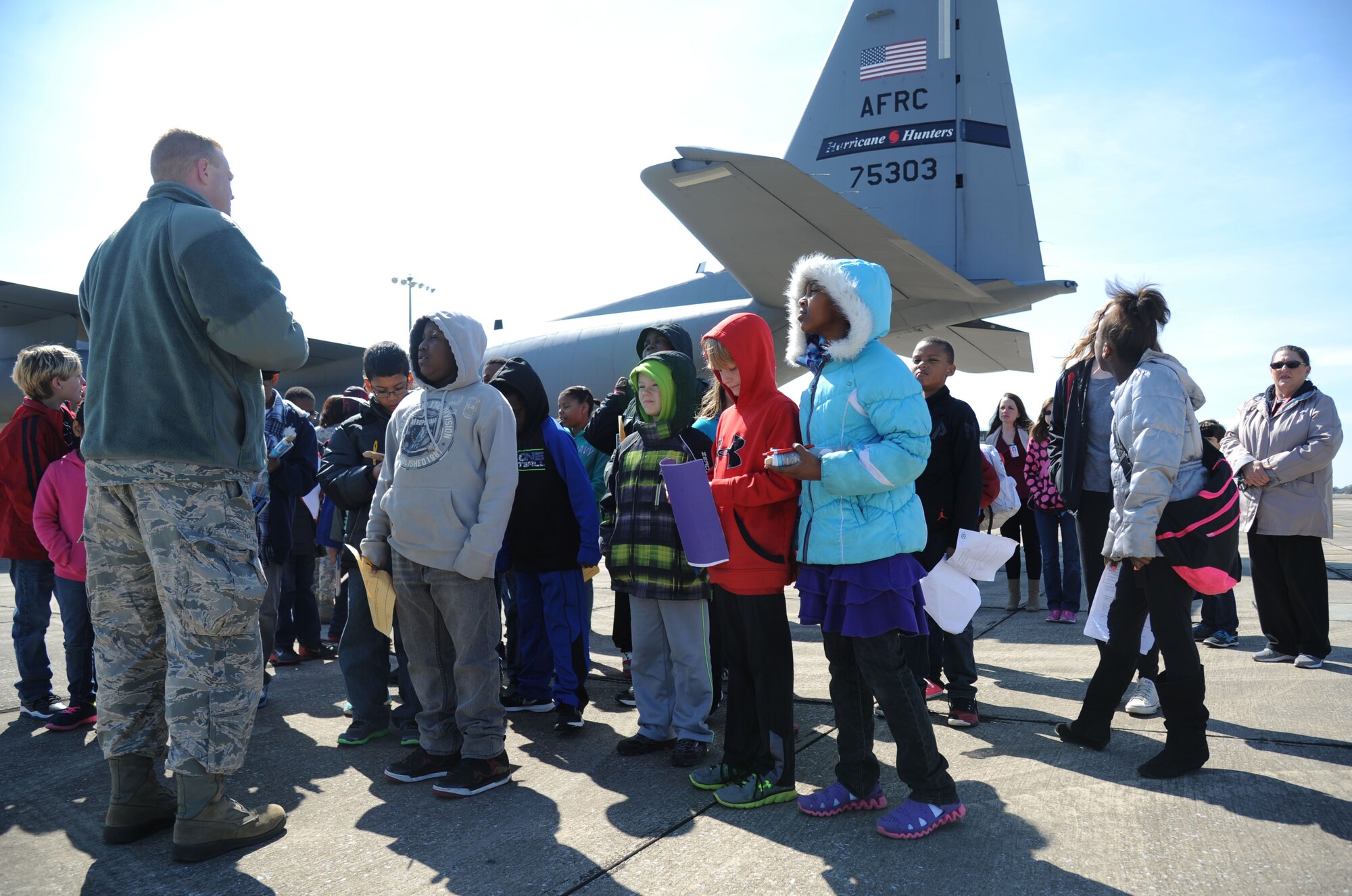 Master Sgt. Brian Lamar, 403rd Wing public affairs specialist, provides a tour of a C-130J Super Hercules to school-aged children during Biloxi Career Exploration Day Feb. 19, 2015, outside the weather complex, Keesler Air Force Base, Miss.  The children also toured the 334th Training Squadron, the 335th TRS, the 81st Security Forces Squadron canine facility and the Keesler Fire Department.  (U.S. Air Force photo by Kemberly Groue)