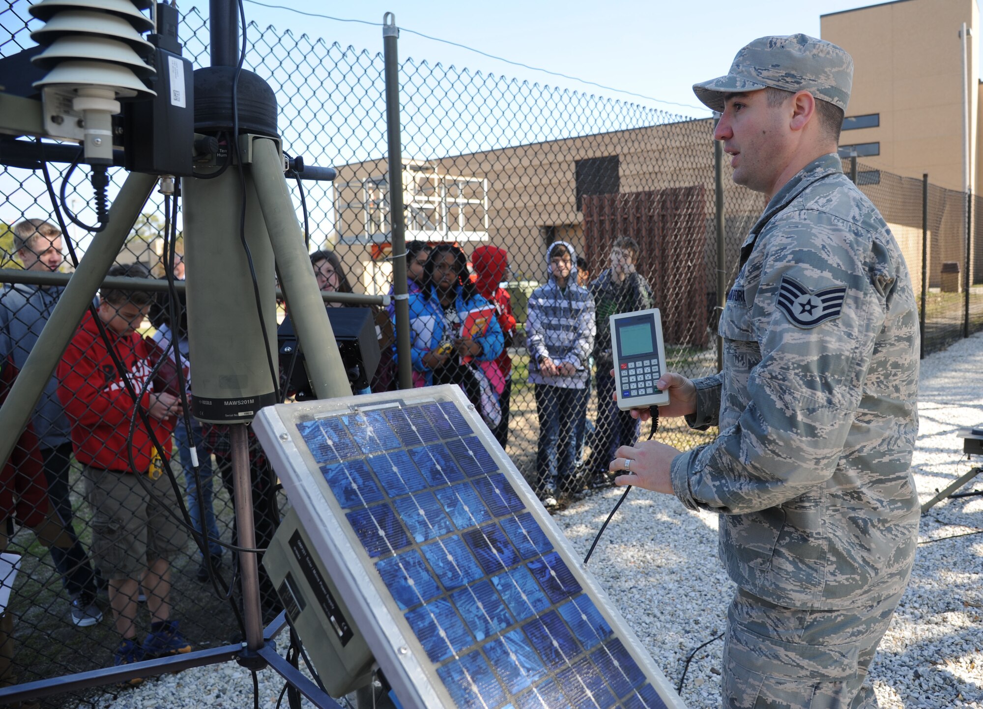 Staff Sgt. Keven Blackman, 335th Training Squadron weather instructor, shows a tactical meteorological observing system to school-aged children during Biloxi Career Exploration Day Feb. 19, 2015, outside the weather complex, Keesler Air Force Base, Miss.  The children also toured the 334th TRS, the 81st Security Forces Squadron canine facility, the Keesler Fire Department and the 403rd Wing.  (U.S. Air Force photo by Kemberly Groue)
