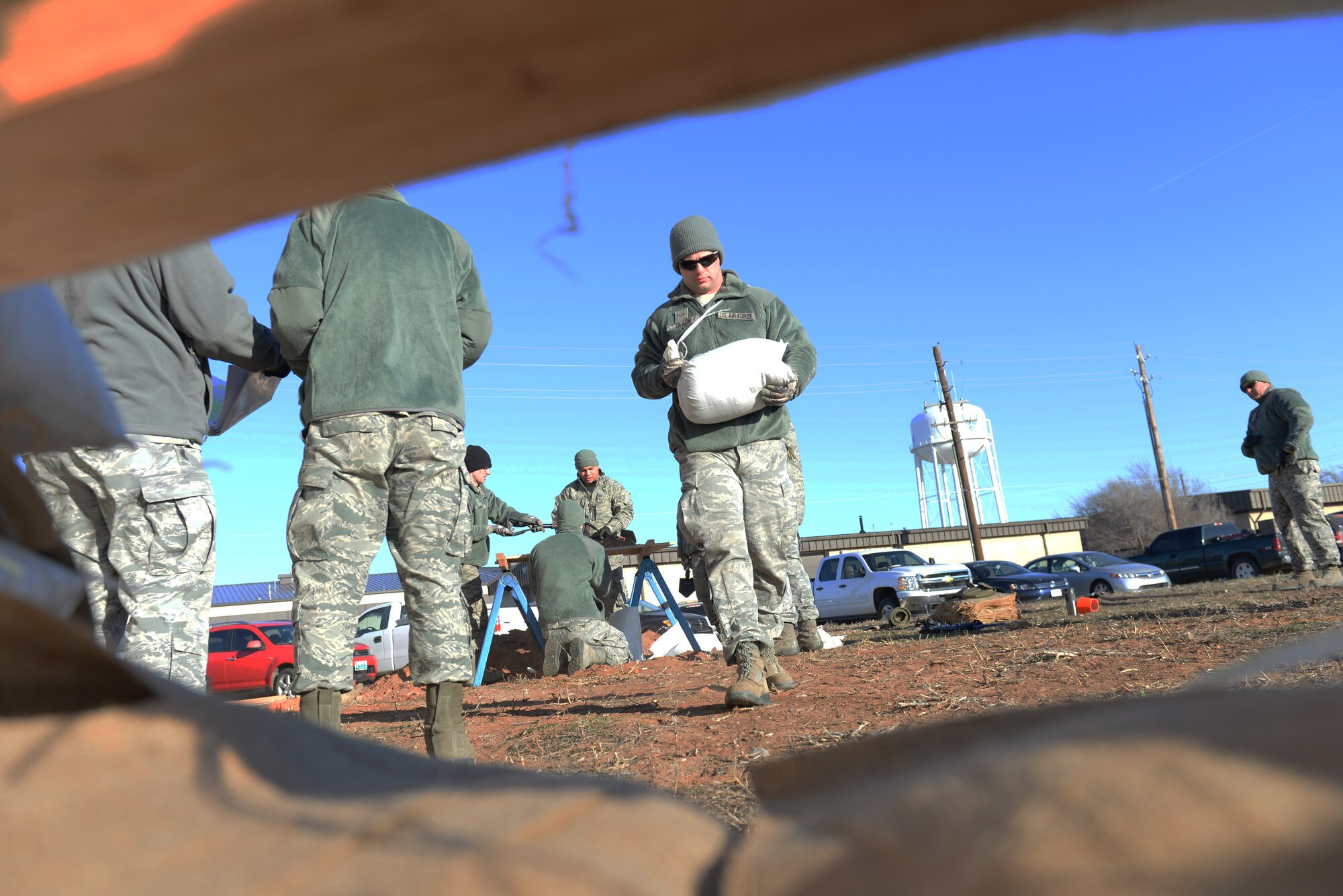 ALTUS AIR FORCE BASE, Okla. – U.S. Air Force Airman 1st Class Robert Black, 97th Civil Engineer Squadron structural journeyman, carries a sandbag to fortify a defensive fight position during a Prime Base Engineer Emergency Force exercise, Feb. 19, 2015. During the exercise, the squadron, separated into four flights, completed training on methods for searching large areas, building defensive fighting positions, extracting unconscious victims and handling unidentified vehicles approaching the installation. (U.S. Air Force photo by Airman 1st Class J. Zuriel Lee/Released)