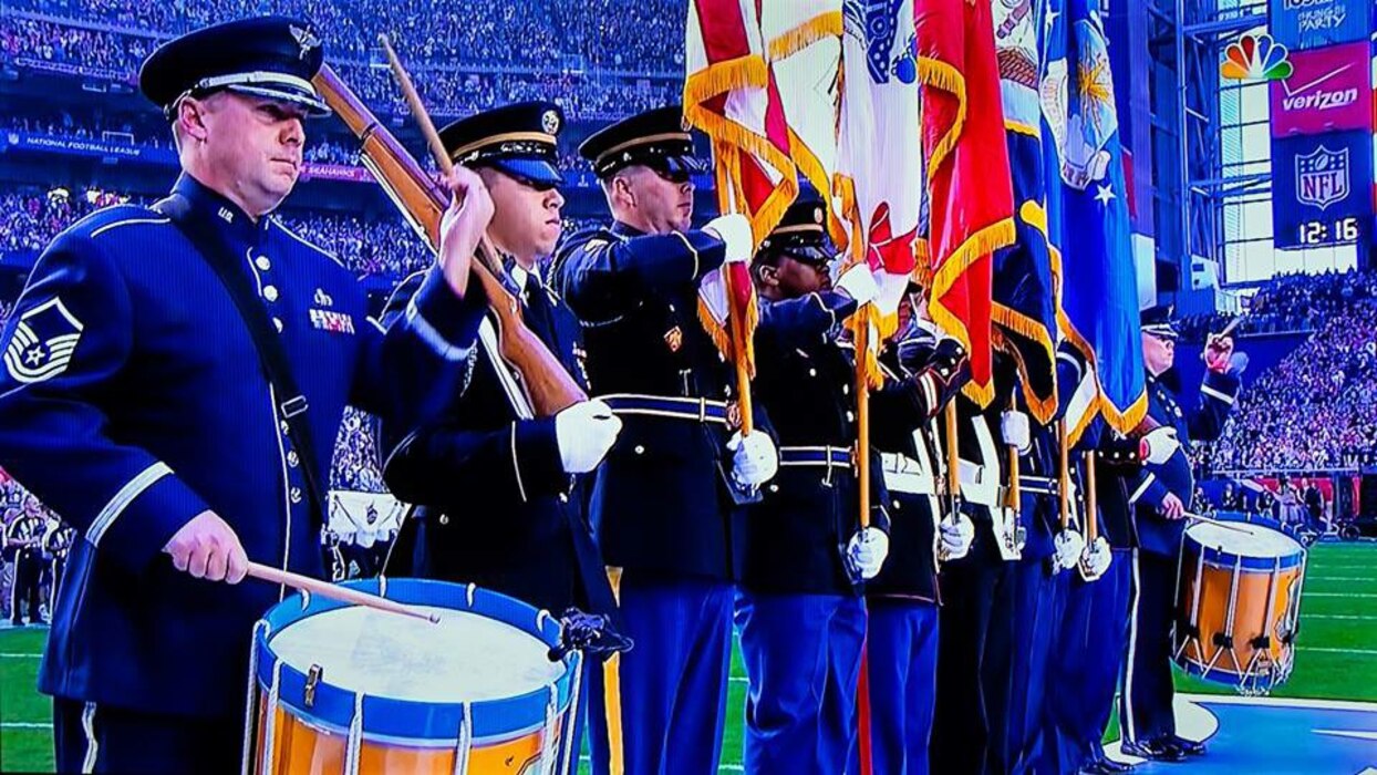 Ceremonial Brass drummers Master Sergeant Tom Rarick and Senior Master Sergeant Chris Martin, along with the Joint Service Honor Guard, got some great screen time during their performance at the opening ceremonies for Super Bowl XLIX. (U.S. Air Force photo/released)
