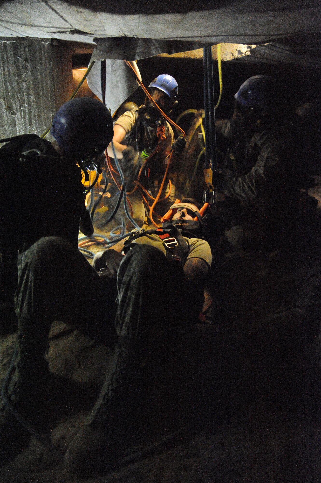 Students prepare to raise a “victim” to safety during confined space rescue operations training Feb. 13, 2015, at the medical center, Keesler Air Force Base, Miss.  Keesler hosted the one-time advanced rescue certification training course, which consisted of confined space rescue, high and low angle rescue and stokes basket rescue operations.  Eleven students from four bases completed the course.  (U.S. Air Force photo by Kemberly Groue)