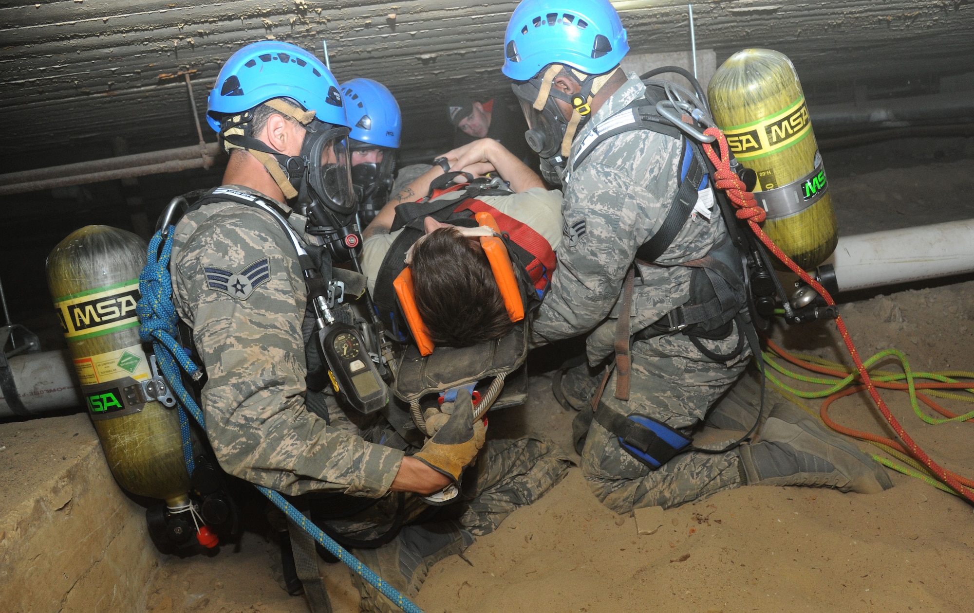 Students maneuver a “victim” to safety during confined space rescue operations training Feb. 13, 2015, at the medical center, Keesler Air Force Base, Miss.  Keesler hosted the one-time advanced rescue certification training course, which consisted of confined space rescue, high and low angle rescue and stokes basket rescue operations.  Eleven students from four bases completed the course.  (U.S. Air Force photo by Kemberly Groue)