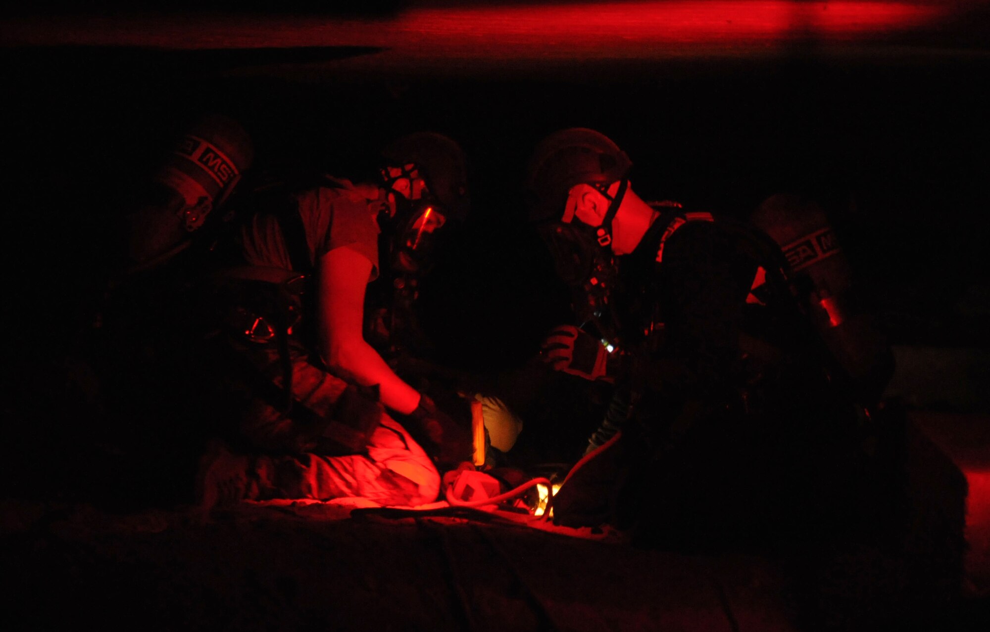 Senior Airman Aaron White, 81st Infrastructure Division firefighter, and Frank Koger, Naval Construction Battalion Center firefighter and emergency medical technician, Gulfport, Miss., adjust their ropes while rescuing a “victim” during confined space rescue operations training Feb. 13, 2015, at the medical center, Keesler Air Force Base, Miss.  Keesler hosted the one-time advanced rescue certification training course, which consisted of confined space rescue, high and low angle rescue and stokes basket rescue operations.  Eleven students from four bases completed the course.  (U.S. Air Force photo by Kemberly Groue)
