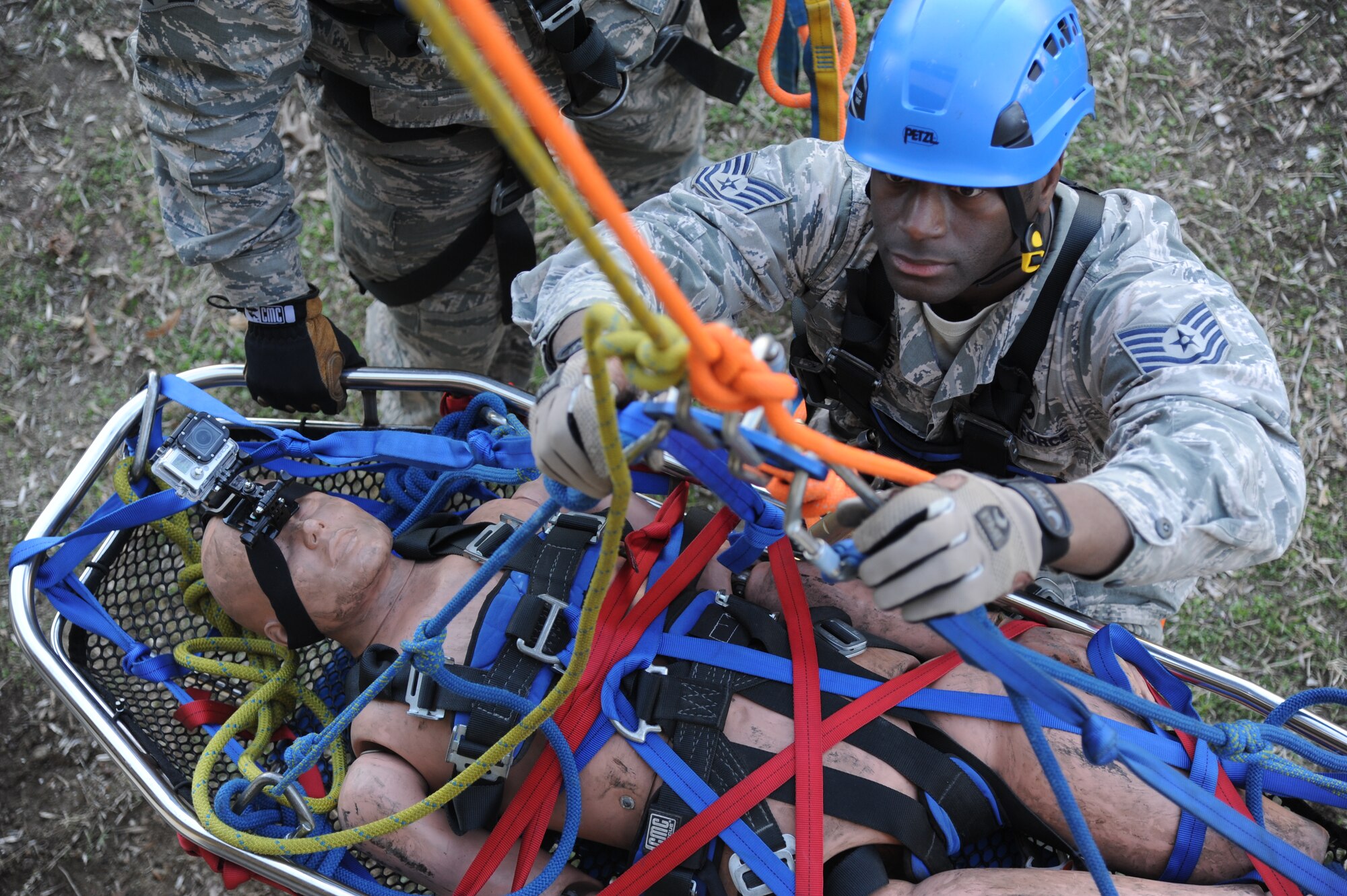 Tech. Sgt. Lawrence Ricks, 81st Infrastructure Division firefighter, settles himself as he is being raised during basket raising rescue operations training Feb. 6, 2015, at Keesler Air Force Base, Miss.  Keesler hosted the one-time advanced rescue certification training course, which consisted of confined space rescue, high and low angle rescue and stokes basket rescue operations.  Eleven students from four bases completed the course.  (U.S. Air Force photo by Kemberly Groue)