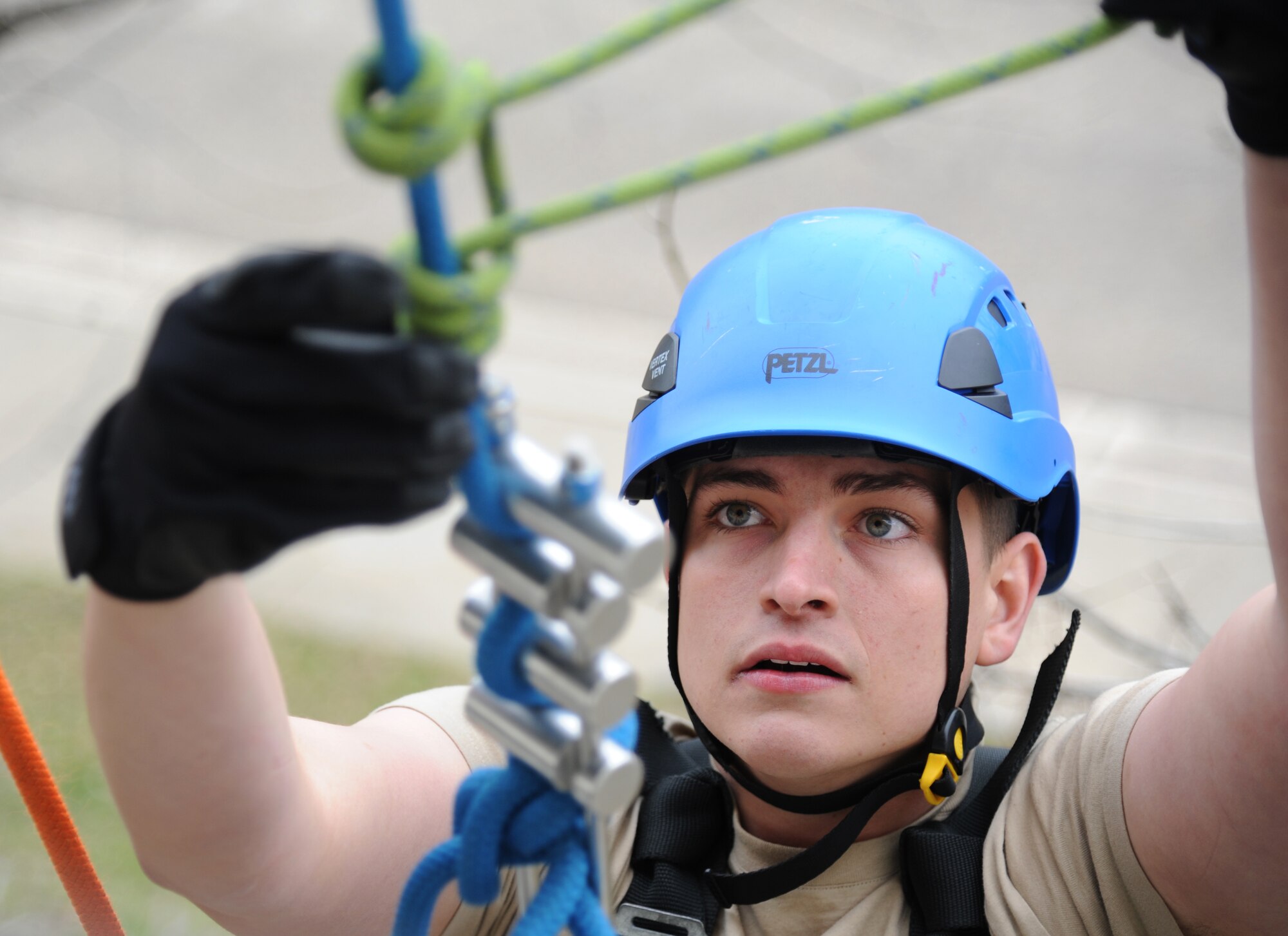 Senior Airman Aaron White, 81st Infrastructure Division firefighter, rappels down the side of a building during rescue operations training Feb. 3, 2015, at Keesler Air Force Base, Miss.  The one-time advanced rescue certification training course consisted of confined space, high and low angle rescue and stokes basket rescue operations.  Eleven students from four bases completed the course.  (U.S. Air Force photo by Kemberly Groue)