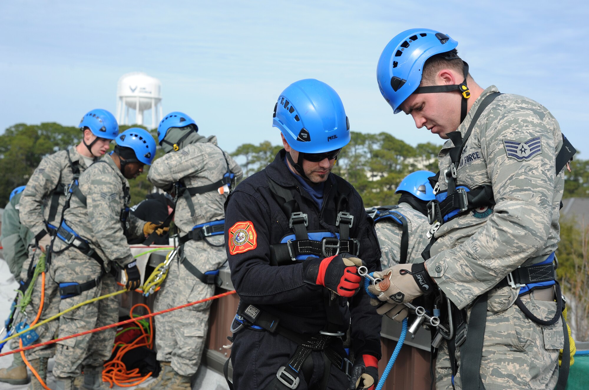 Frank Koger,  Naval Construction Battalion Center firefighter and emergency medical technician, Gulfport, Miss., assists Staff Sgt. John Hood, 81st Infrastructure Division firefighter, with an equipment safety check during rescue operations training Feb. 3, 2015, at Keesler Air Force Base, Miss.  The one-time advanced rescue certification training course consisted of confined space, high and low angle rescue and stokes basket rescue operations.  Eleven students from four bases completed the course.  (U.S. Air Force photo by Kemberly Groue)