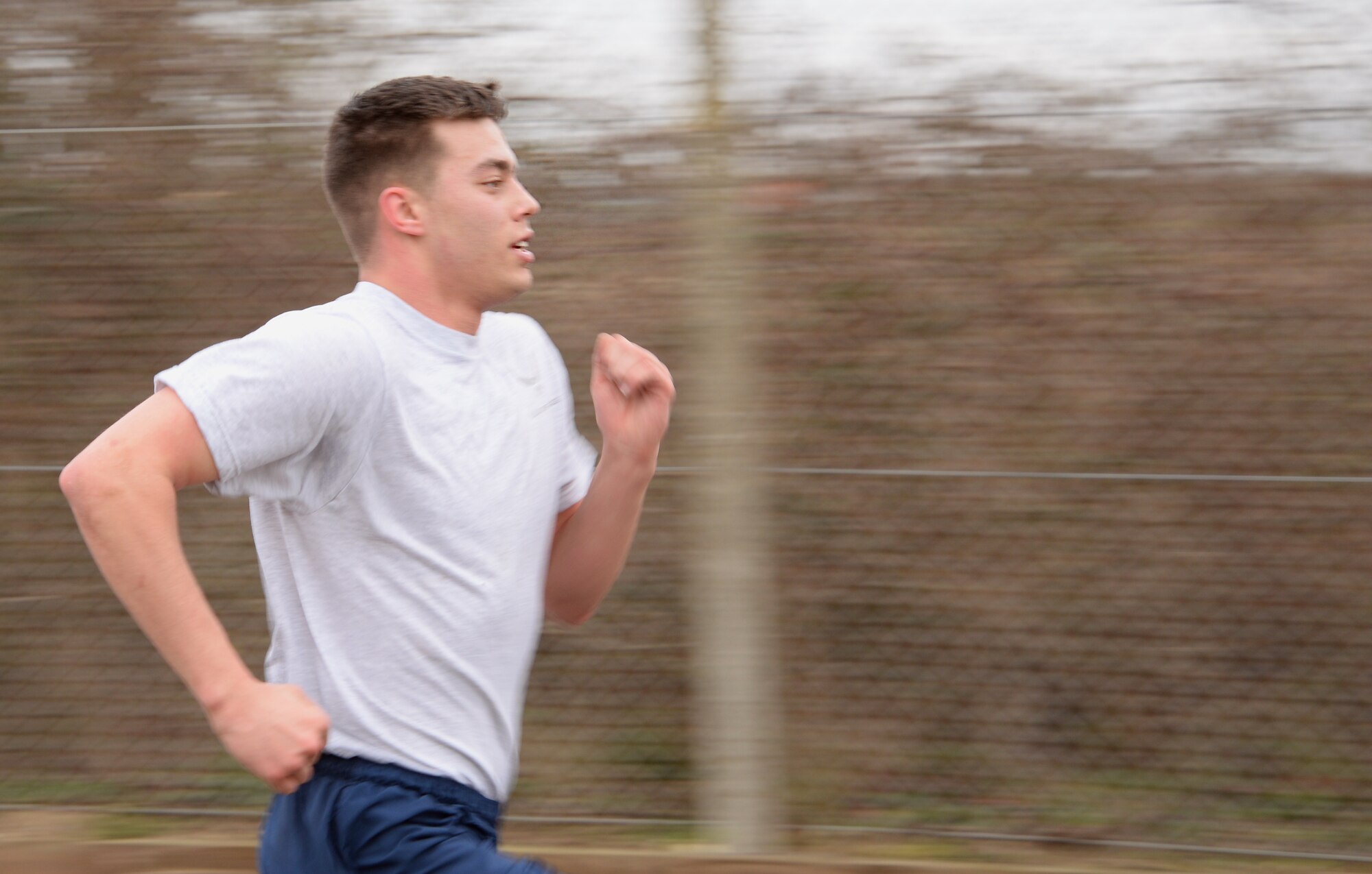 U.S. Air Force Airman 1st Class Anthony Tidwell, 100th Force Support Squadron force management apprentice from St Paul, Minn., approaches the finish line of a wing run Feb. 20, 2015, on RAF Mildenhall, England. The monthly 5 km run encourages physical fitness, morale and camaraderie through healthy competition. (U.S. Air Force photo by Airman 1st Class Jonathan Light/Released) 