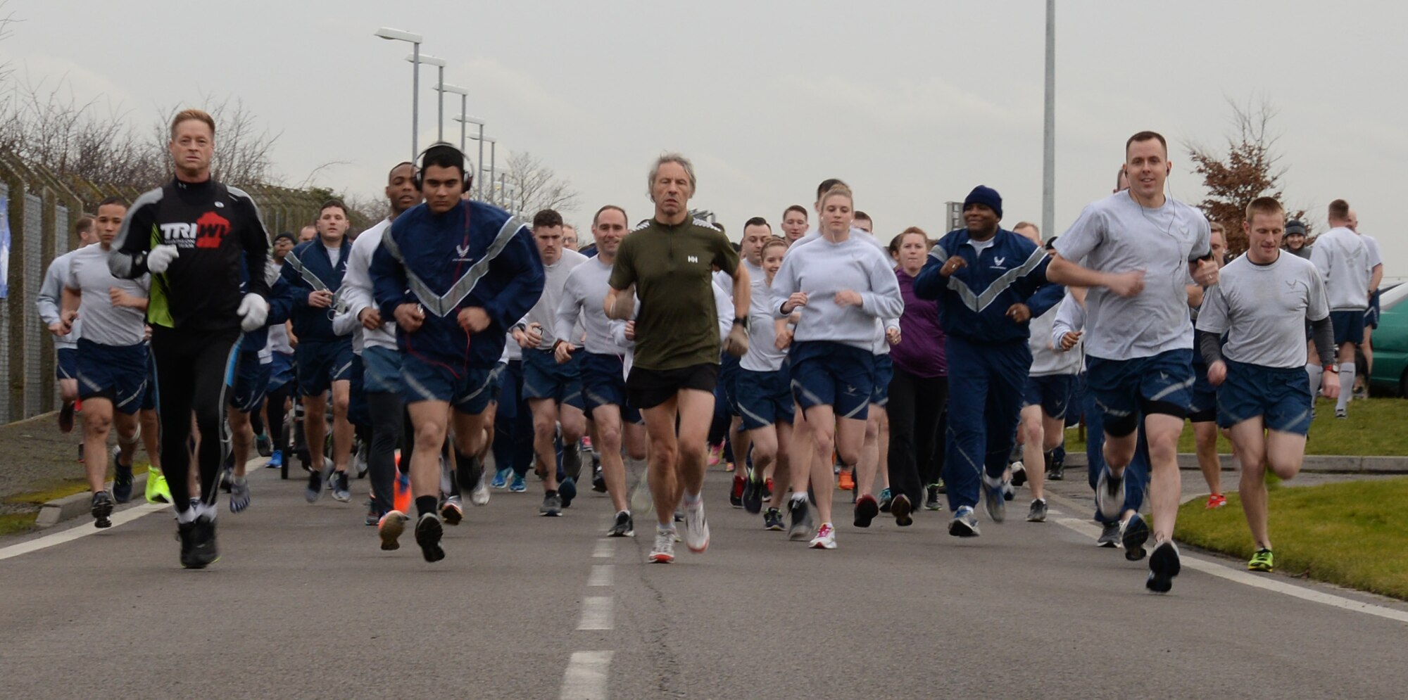 Team Mildenhall members kick off a 100th Air Refueling Wing 5 km run Feb. 20, 2015, on RAF Mildenhall, England. Starting at the Hardstand Fitness Center parking lot, participants ran along a designated base perimeter route. (U.S. Air Force photo by Airman 1st Class Jonathan Light/Released) 