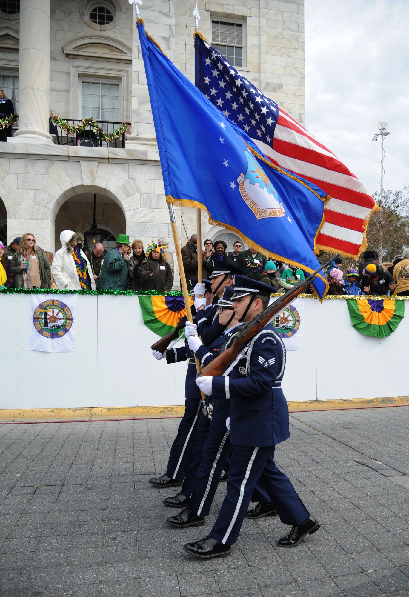The Keesler Air Force Base Honor Guard leads the Gulf Coast Carnival Association Mardi Gras parade Feb. 17, 2015, in Biloxi, Miss.  Base leadership also attended the event.  (U.S. Air Force photo by Kemberly Groue)