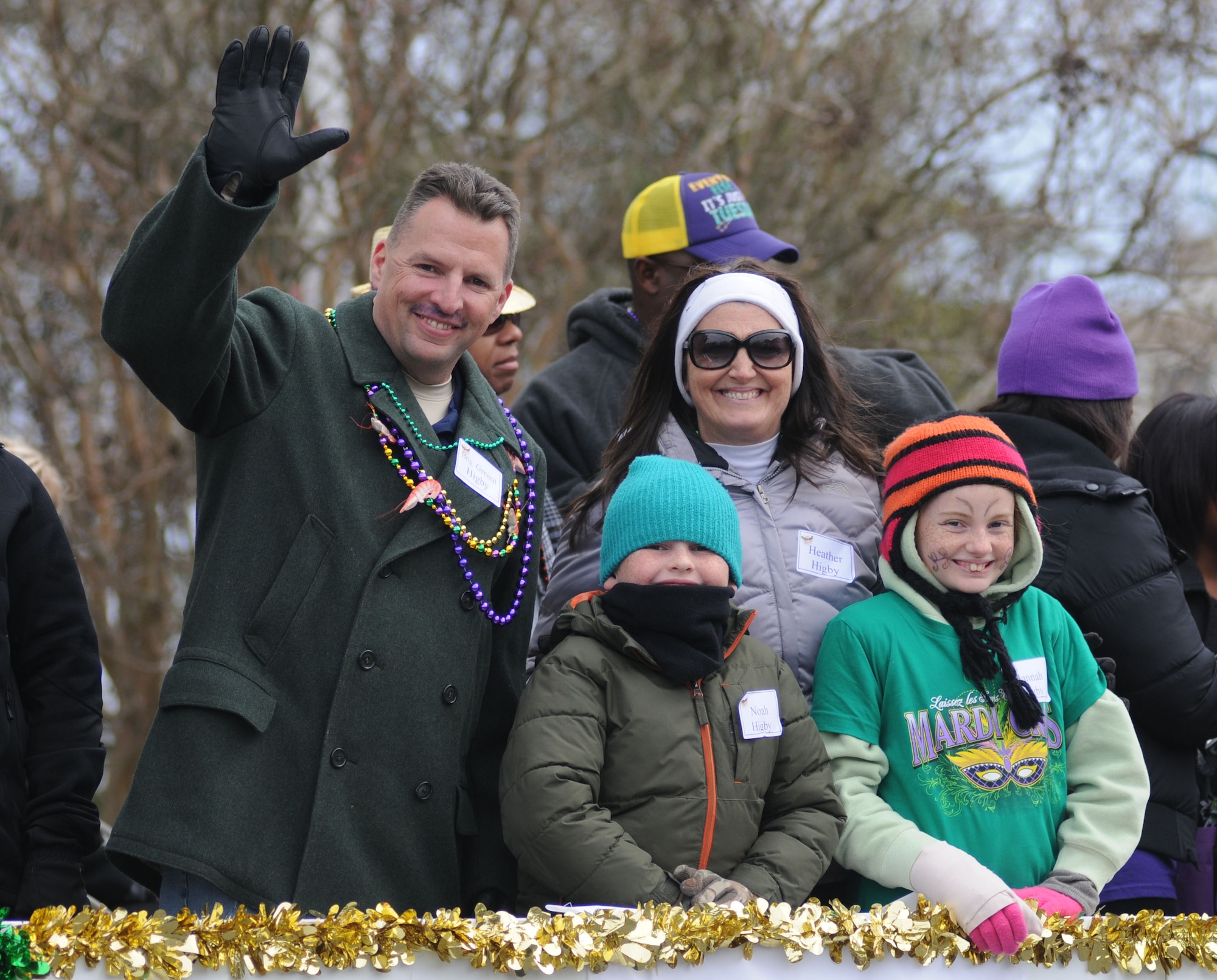 Brig. Gen. Patrick Higby, 81st Training Wing commander, poses for a photo with his wife, Heather, and children, Noah and Hannah, during the Gulf Coast Carnival Association Mardi Gras parade Feb. 17, 2015, in Biloxi, Miss.  The Keesler Honor Guard led the parade and other base leadership also attended the event.  (U.S. Air Force photo by Kemberly Groue)