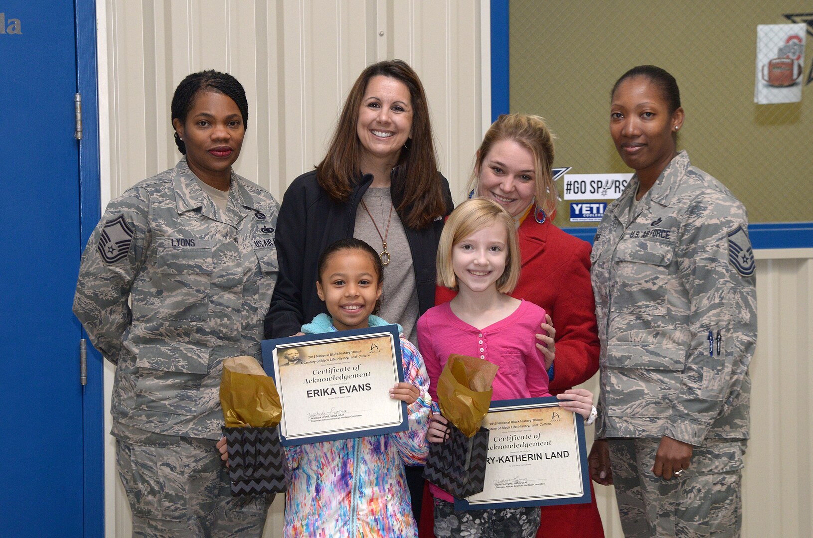 The Joint Base San Antonio-Randolph African American Heritage Committee hosted an essay writing contest themed “A Century of Black Life, History, and Culture.” Winners Erika Evans (front left), third-grade student; and Mary-Katherin Land (front right), fourth grade student; were awarded certificates Feb. 5 at Joint Base San Antonio-Randolph.
Back row, from left: Senior Master Sgt. Yasheda Lyons, African American Heritage Committee chairman; Angie Schneider, Randolph Elementary School third-grade teacher; Laurie Tabeb, Randolph Elementary School fourth-grade teacher; and Master Sgt. Nidia Hodge, African American Heritage Committee co-chairman; presented the certificates. 
(U.S. Air Force photo by Johnny Saldivar)
