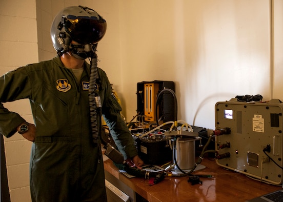 Col. Scott Thompson, 96th Operations Group commander, checks the fit of his Joint Helmet Mounted Cueing System visor at the Aircrew Flight Equipment facility on Eglin Air Force Base, Fla., Feb. 9.  The JHMCS is a modified HGU-55/P helmet that incorporates a visor projected Heads-Ups Display to cue weapons and sensors to the target. The maintenance of the helmets is critical to the pilot’s performance and safety.  (U.S. Air Force photo/Ilka Cole) 