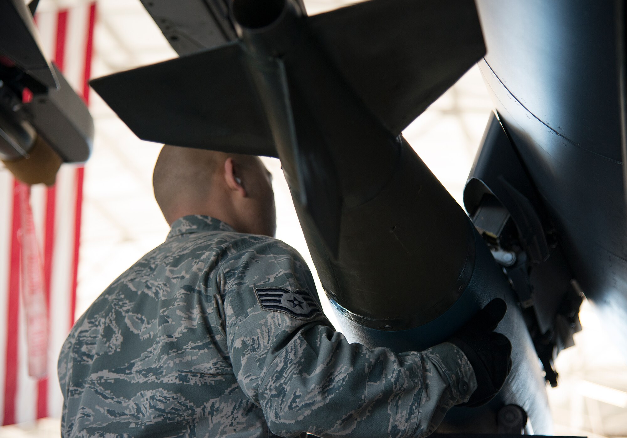 Staff Sgt. Adrian Pamintuan, 96th Aircraft Maintenance Squadron, moves a guided bomb unit into place on an F-15 Eagle during the annual weapons load crew of the year competition Feb. 13 at Eglin Air Force Base, Fla.  Two F-16 Fighting Falcon and two F-15 teams loaded five weapons on their respective aircraft for the rights to be the load crew of the year for 2014.  The timed competition is judged on safety, speed and accuracy.  The winner of the competition will be announced at the 96th Maintenance Group’s annual awards banquet in March.  (U.S. Air Force photo/Tech. Sgt. Jasmin Taylor)