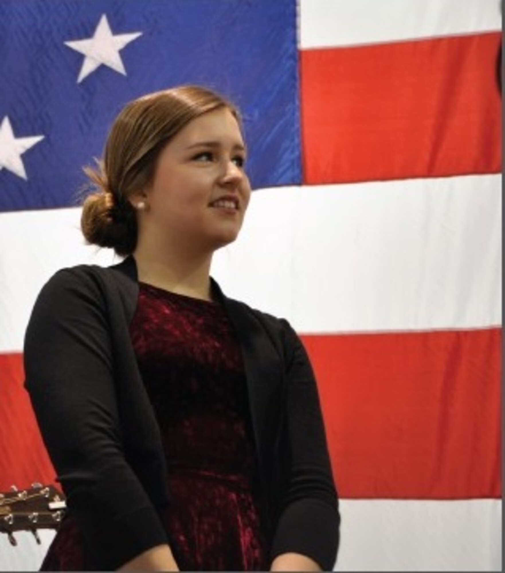 Singer/Songwriter Gracie Schram prepares to entertain the men and women of the 442d Fighter Wing with her vocal talents during the December Welcome Home event in the 5-Bay hangar here. Schram's debut studio album will be released in May 2015. (U.S. Air Force photo by Captain Denise Haeussler)