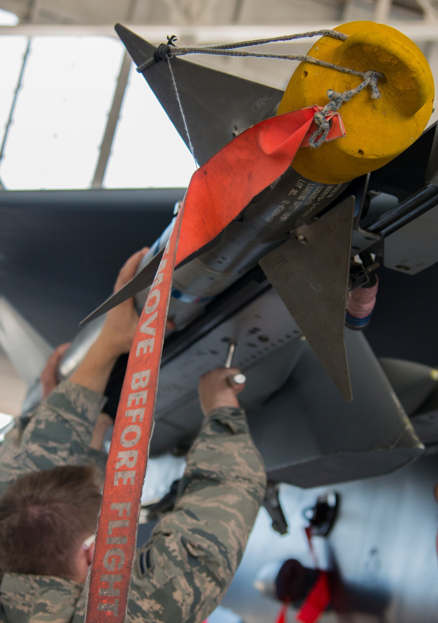 Airman 1st Class Vadim Milligan, 96th Aircraft Maintenance Squadron, secures an AIM-9X on an F-15 Eagle during the annual weapons load crew of the year competition Feb. 13 at Eglin Air Force Base, Fla.  Two F-16 Fighting Falcon and two F-15 teams loaded five weapons on their respective aircraft for the rights to be the load crew of the year for 2014.  The timed competition is judged on safety, speed and accuracy.  The winner of the competition will be announced at the 96th Maintenance Group’s annual awards banquet in March.  (U.S. Air Force photo/Tech. Sgt. Jasmin Taylor)