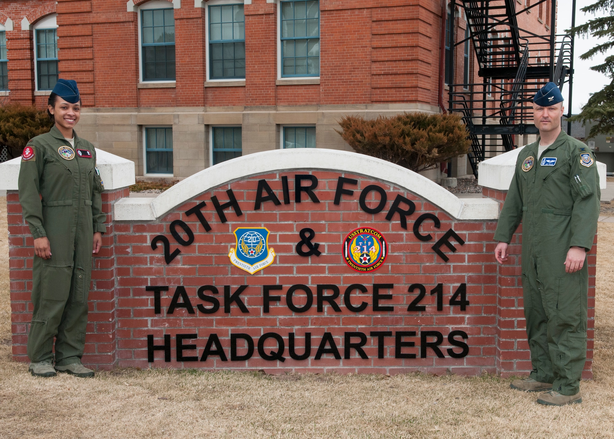 2nd Lt. Caryn Morales, 320th Missile Squadron, and Col. Jay Folds, 20th Air Force director of operations, pose in front of 20th AF and Task Force 214 headquarters, on F.E. Warren Air Force Base, Wyo., Feb. 20, 2015. Folds is the first colonel  since the mid-1990s to pull alert at a launch control center in the missile fields near Cheyenne. (U.S. Air Force photo by Lan Kim)
