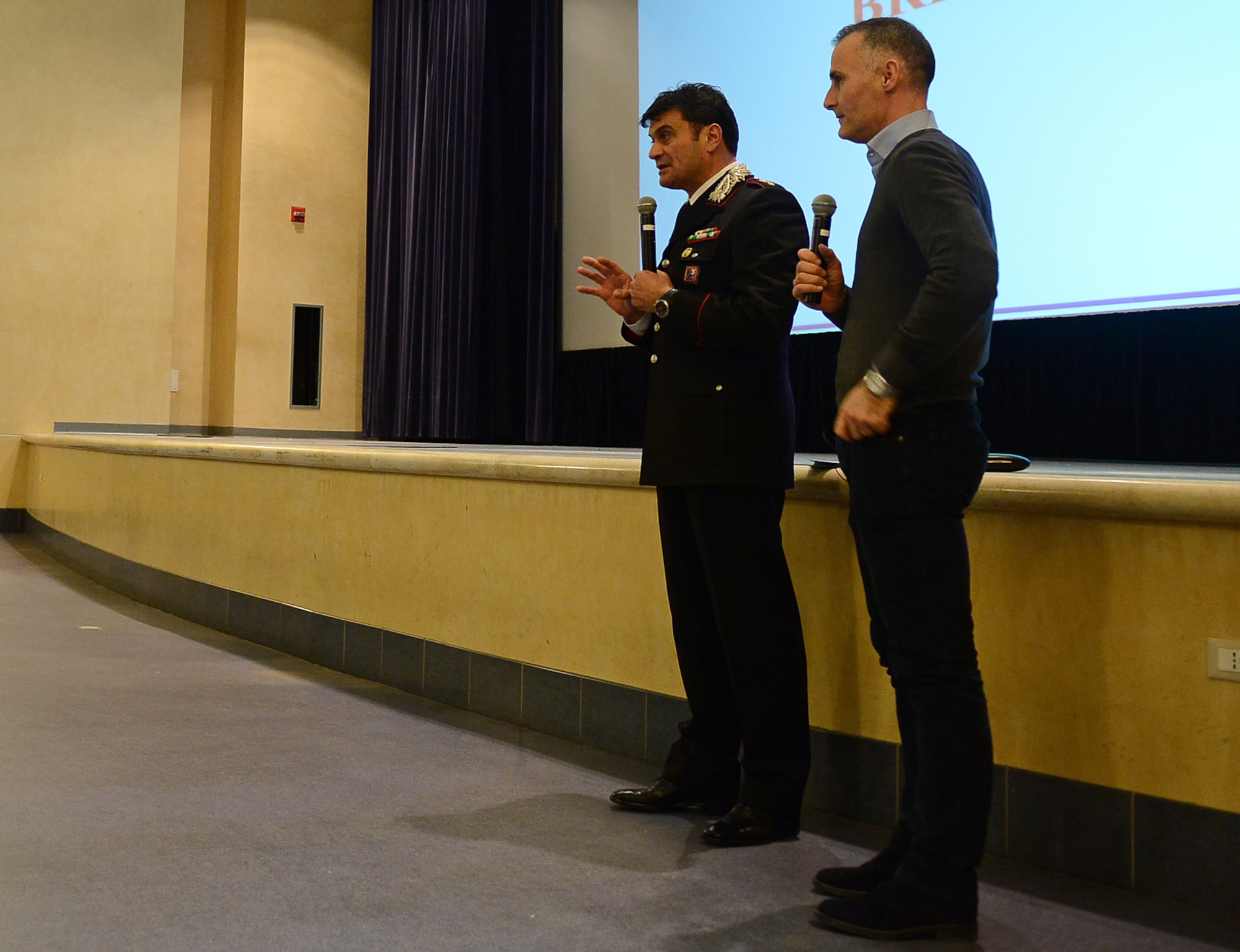 Capt. Pierluigi Grosseto, Sacile Carabinieri Station commander, talks to Team Aviano members with the help of Gianni Vignaduzzi, 31st Security Forces Squadron interpreter, Feb. 19, 2015, at Aviano Air Base, Italy. Grosseto instructed attendees to call “112” when off base and from mobile devices in the case of an emergency situation. (U.S. Air Force photo by Staff Sgt. R.J. Biermann/Released)