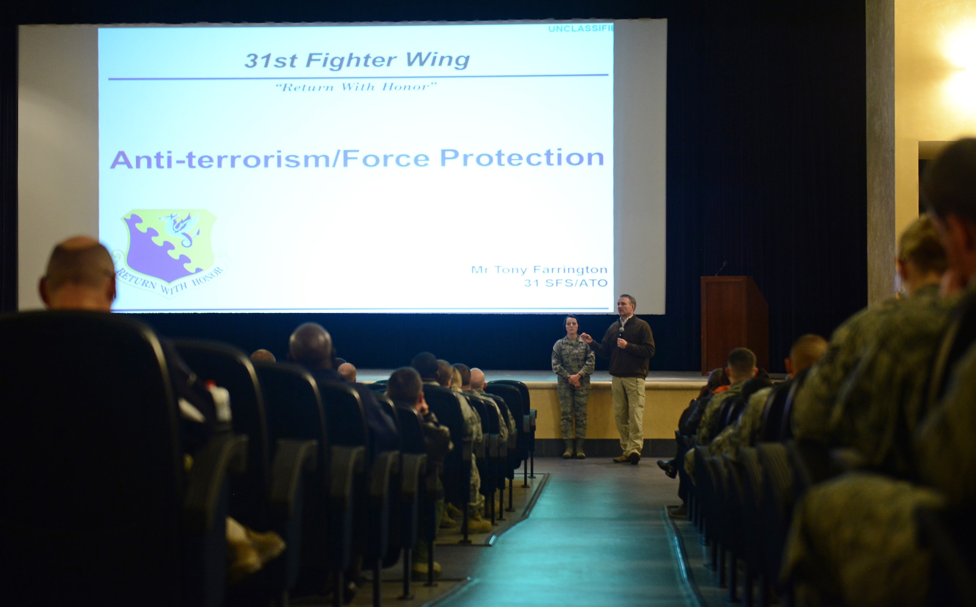 Tony Farrington, 31st Security Forces Squadron Antiterrorism program manager, discusses personal security during a town hall meeting, Feb. 19, 2015, at Aviano Air Base, Italy. The town hall meeting was aimed at educating individuals on various practices and deterrents to help protect a person’s identity and belongings. (U.S. Air Force photo by Staff Sgt. R.J. Biermann/Released)