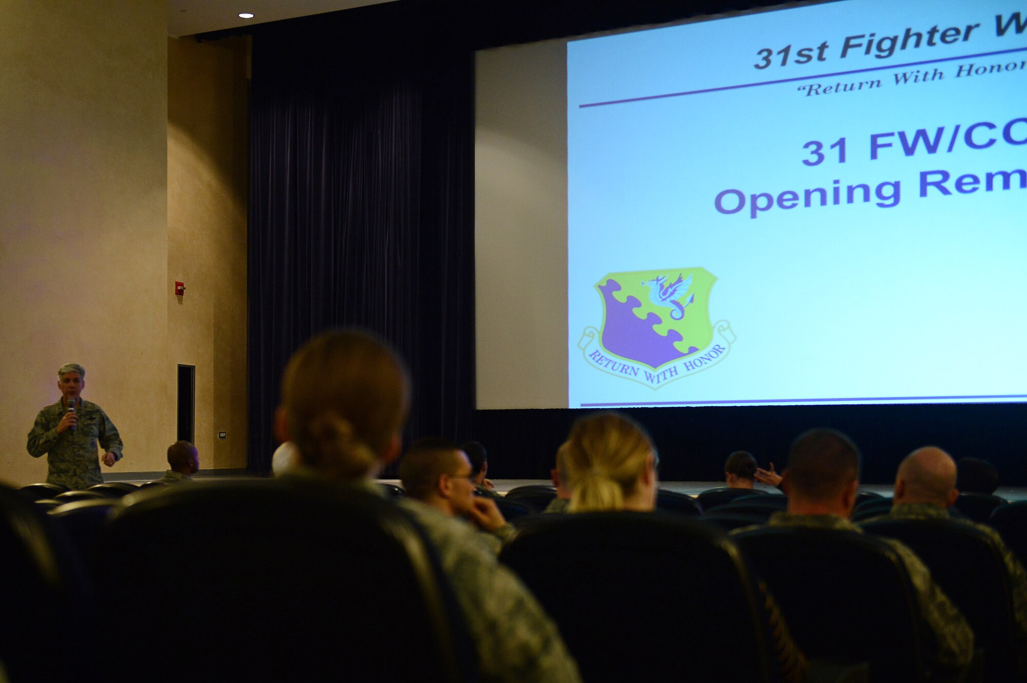 Brig. Gen. Barre Seguin, 31st Fighter Wing commander, welcomes Team Aviano members to a town hall meeting, Feb. 19, 2015, at Aviano Air Base, Italy. The town hall was aimed at educating individuals on how to safeguard their identities and protect themselves from home break-ins. (U.S. Air Force photo by Staff Sgt. R.J. Biermann/Released)
