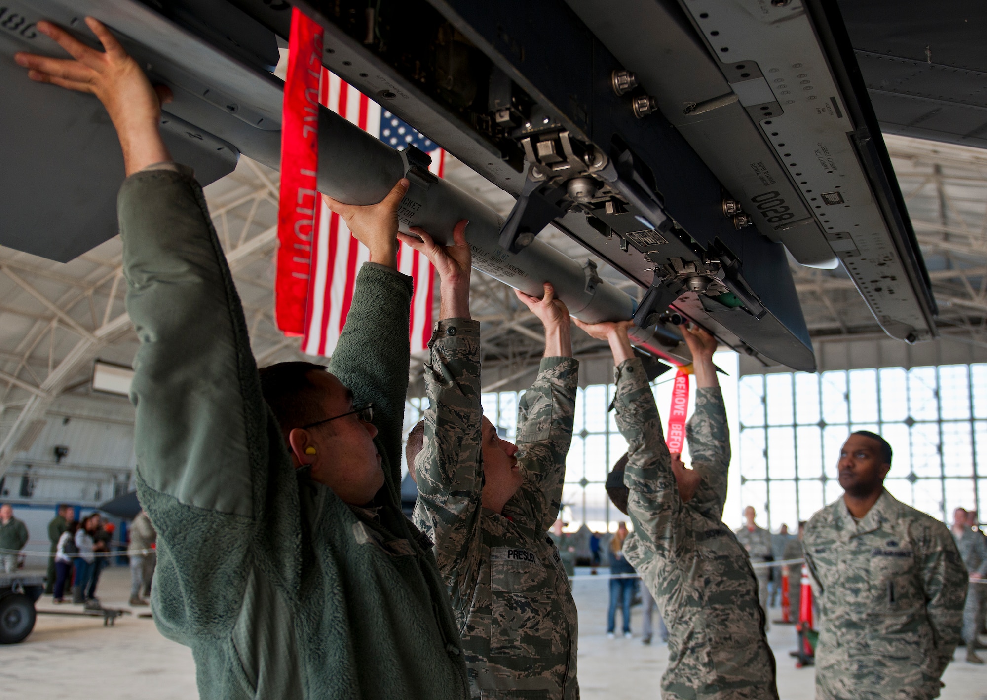 A 96th Aircraft Maintenance Squadron Red F-15 Eagle team lifts up an AIM-9X missile onto their aircraft during the annual weapons load crew of the year competition Feb. 13 at Eglin Air Force Base, Fla.  Two F-16 Fighting Falcon and two F-15 teams loaded five weapons on their respective aircraft for the rights to be the load crew of the year for 2014.  The timed competition is judged on safety, speed and accuracy.  The winner of the competition will be announced at the 96th Maintenance Group’s annual awards banquet in March.  (U.S. Air Force photo/Samuel King Jr.)