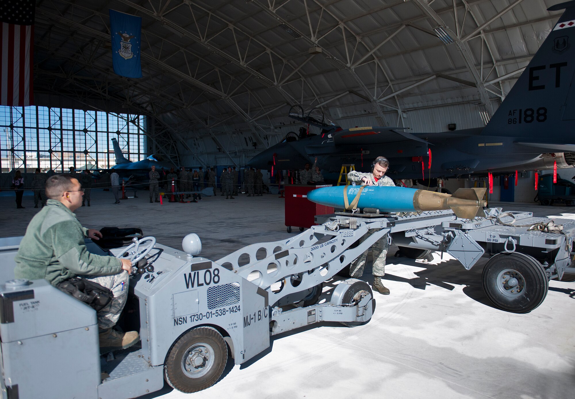 A 96th Aircraft Maintenance Squadron Red F-15 Eagle team moves a guided bomb unit toward their aircraft during the annual weapons load crew of the year competition Feb. 13 at Eglin Air Force Base, Fla.  Two F-16 Fighting Falcon and two F-15 teams loaded five weapons on their respective aircraft for the rights to be the load crew of the year for 2014.  The timed competition is judged on safety, speed and accuracy.  The winner of the competition will be announced at the 96th Maintenance Group’s annual awards banquet in March.  (U.S. Air Force photo/Samuel King Jr.)